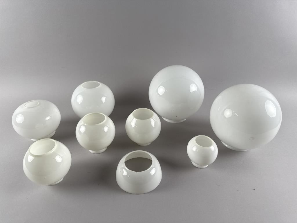 NINE MILK GLASS SHADES 19th Century: NINE MILK GLASS SHADES19th Century1-6) Six oil lamp globe shades with openings at top and bottom. Heights from 3.5" to 6". Diameters from 3" to 5.5".7) One oil lamp hemisphere shade. Height 2". Diamet