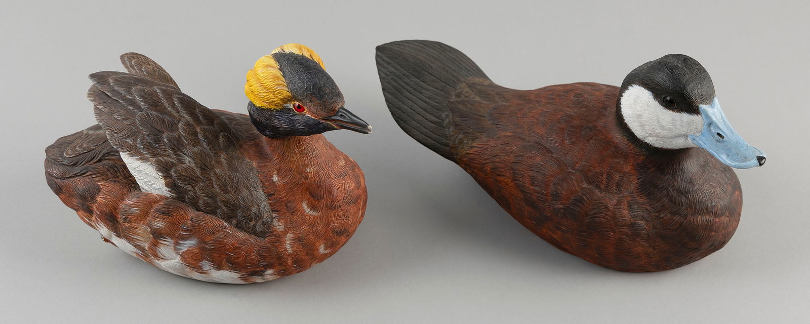 TWO ROSCOE A. CONDON DECORATIVE BIRD CARVINGS Fitchburg, Massachusetts, 1935-2025 Lengths 8" and: TWO ROSCOE A. CONDON DECORATIVE BIRD CARVINGSFitchburg, Massachusetts, 1935-2025A grebe and ruddy duck drake.Lengths 8" and 11".