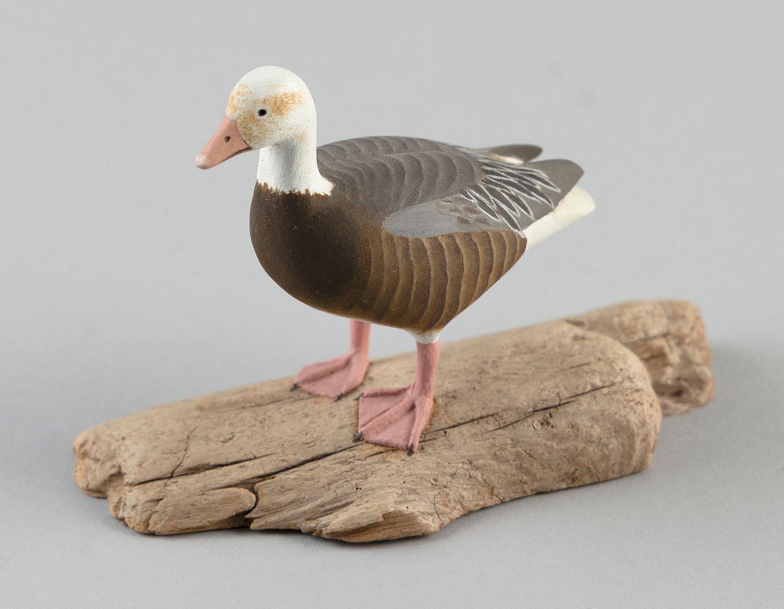 HAROLD GIBBS MINIATURE BLUE GOOSE Barrington, Rhode Island, 1886-1970 Height 3.5".: HAROLD GIBBS MINIATURE BLUE GOOSEBarrington, Rhode Island, 1886-1970Mounted on a driftwood base. Signed and dated "H Gibbs 1964".Height 3.5".