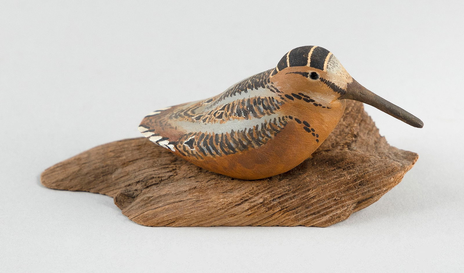 HAROLD GIBBS MINIATURE WOODCOCK Barrington, Rhode Island, 1886-1970 Height 2".: HAROLD GIBBS MINIATURE WOODCOCKBarrington, Rhode Island, 1886-1970Mounted on a driftwood base. Signed "HG".Height 2".