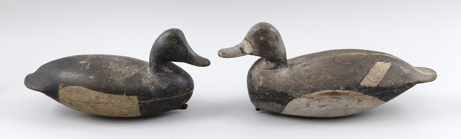 PAIR OF NEW JERSEY BLUEBILL DECOYS Early 20th Century Lengths 14" and 16".: PAIR OF NEW JERSEY BLUEBILL DECOYSEarly 20th CenturyHollow-carved.Lengths 14" and 16".