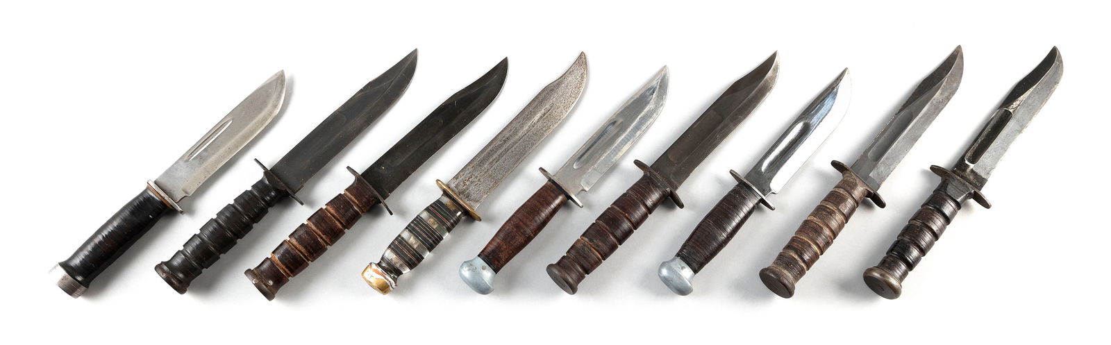 NINE KNIVES 20th Century Lengths 11 and 12".: NINE KNIVES20th CenturyAll but one with sheaths. Includes:1-3) Three U.S.N. Mark 2. One stamped "USN Mark 2", one stamped "US Camillus" and one unmarked.4-5) Two RH36, all stamped.6) Cattaraugus 225Q,