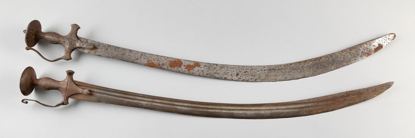 TWO MUGHAL INDIAN TULWAR SWORDS AND SCABBARDS 19th Century Total lengths 36.5".: TWO MUGHAL INDIAN TULWAR SWORDS AND SCABBARDS19th CenturyCanvas-covered scabbards.Total lengths 36.5".