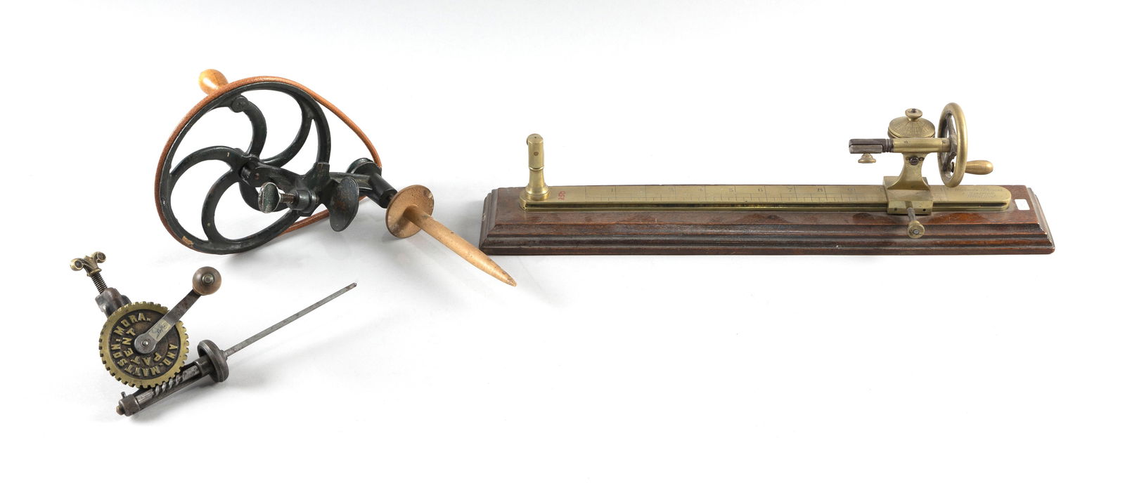 THREE TEXTILE ITEMS Late 19th Century: THREE TEXTILE ITEMSLate 19th Century1) Bronze wool twist tester by Richards, Atkinson & Haserick. Used to test torsion or twist strength of fibers like wool. Engraved maker's mark. Mounted on a mahoga
