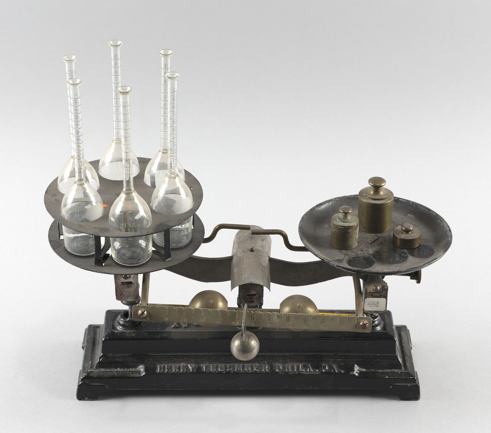 HENRY TROEMNER CO. DAIRY SCALE "606" Philadelphia, Late 19th Century Height including bottles: HENRY TROEMNER CO. DAIRY SCALE "606"Philadelphia, Late 19th CenturyWhite metal painted black. Complete with six milk test bottles. Marked for maker.Height including bottles approx. 12.5". Width 14.25"