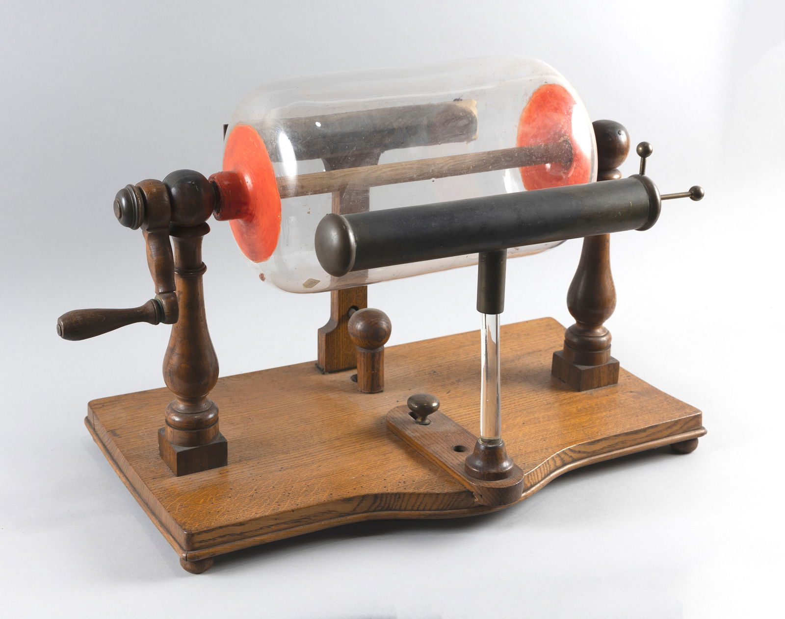 ELECTROSTATIC BARREL MACHINE Late 19th Century Height 17". Width 24.25". Depth 14.5". Barrel: ELECTROSTATIC BARREL MACHINELate 19th CenturyGlass barrel on baluster-turned wood columns set atop an oak plinth. Apparently unmarked.Height 17". Width 24.25". Depth 14.5". Barrel diameter approx. 8.2