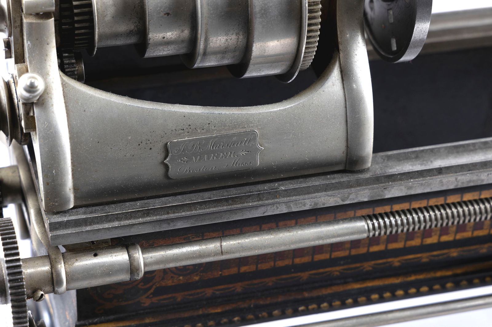 JOSEPH B. MARSHALL TABLETOP LATHE Boston, Late 19th Century Height 11". Length 26". Width 8".: JOSEPH B. MARSHALL TABLETOP LATHEBoston, Late 19th CenturyNicely decorated cast iron base. Engraved on label "J.B. Marshall, Maker. Boston, Mass". Includes accessories.Height 11". Length 26". Width 8"