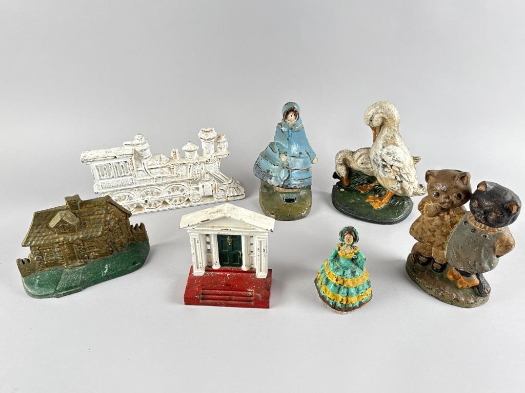 SEVEN CAST IRON DOORSTOPS 20th Century Heights from 5.5" to 9". (1 of 2)
