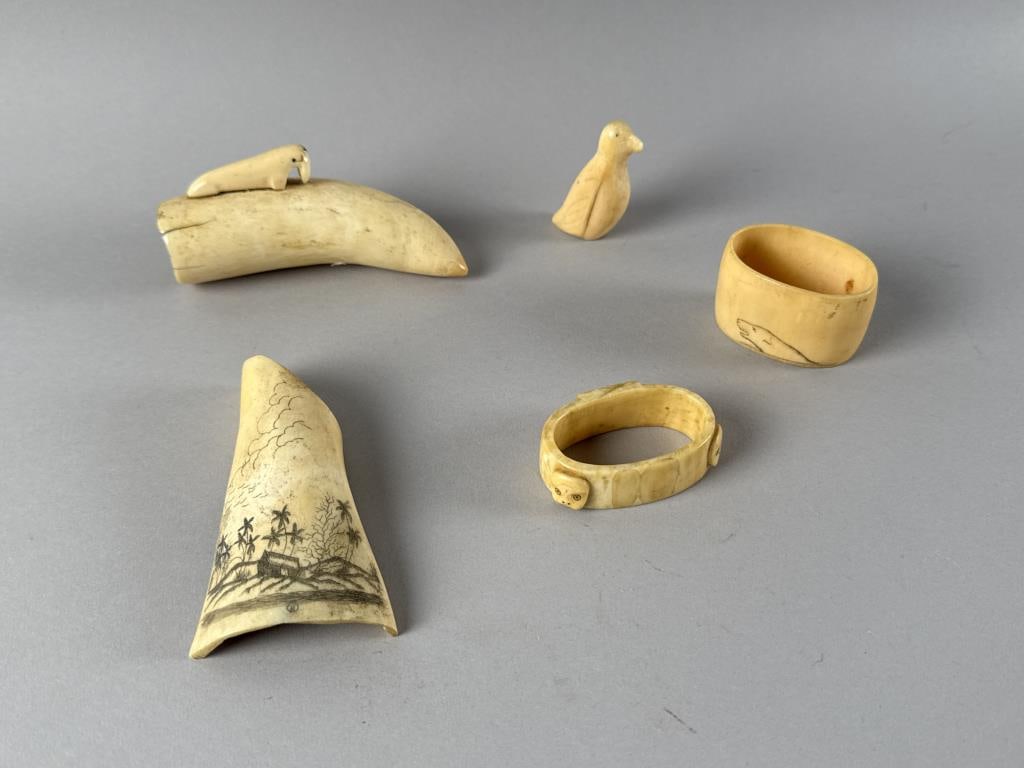 FIVE CARVED ITEMS, MOSTLY ESKIMO First Half of the 20th Century Lengths from 2.25" to 4.25".: FIVE CARVED ITEMS, MOSTLY ESKIMOFirst Half of the 20th Century1-2) Two Eskimo napkin rings.3) Eskimo carving of a bird.4) Eskimo carving of a walrus affixed to a whale's tooth.5) Piece of animal bone