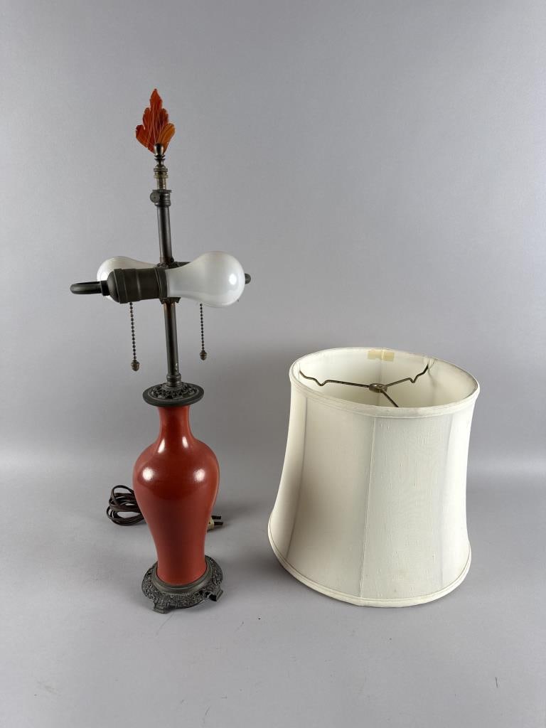 CHINESE TOMATO RED GLAZE PORCELAIN VASE MOUNTED AS A TABLE LAMP 19th Century Vase height 10". Height: CHINESE TOMATO RED GLAZE PORCELAIN VASE MOUNTED AS A TABLE LAMP19th CenturyOrmolu mounts. Agate leaf-form finial.Vase height 10". Height to finial 24".