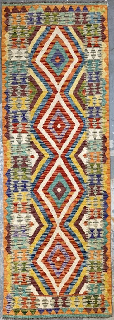 KILIM RUNNER: 3'0" X 8'6" 21st Century: KILIM RUNNER: 3'0" X 8'6"21st CenturyField composed of amethyst, gold, variegated blue, orange and ivory zigzag lines forming a series of linked diamonds. Geometric elements repeat throughout the sing