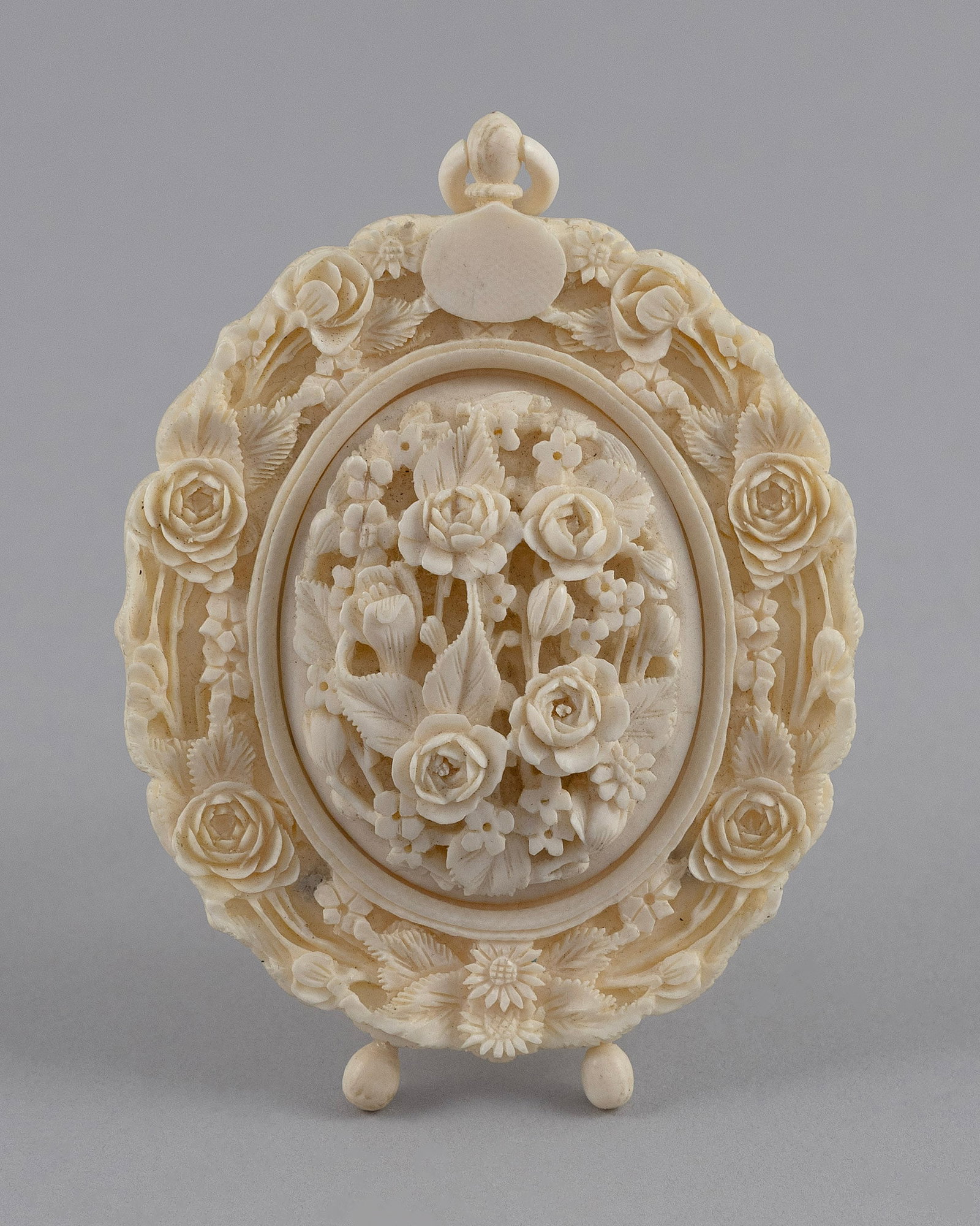 CHINESE EXPORT RELIEF-CARVED IVORY FRAME Second Half of the 19th Century Height 4". Width 2.75".: CHINESE EXPORT RELIEF-CARVED IVORY FRAMESecond Half of the 19th CenturyFloral and dragon design.Height 4". Width 2.75".