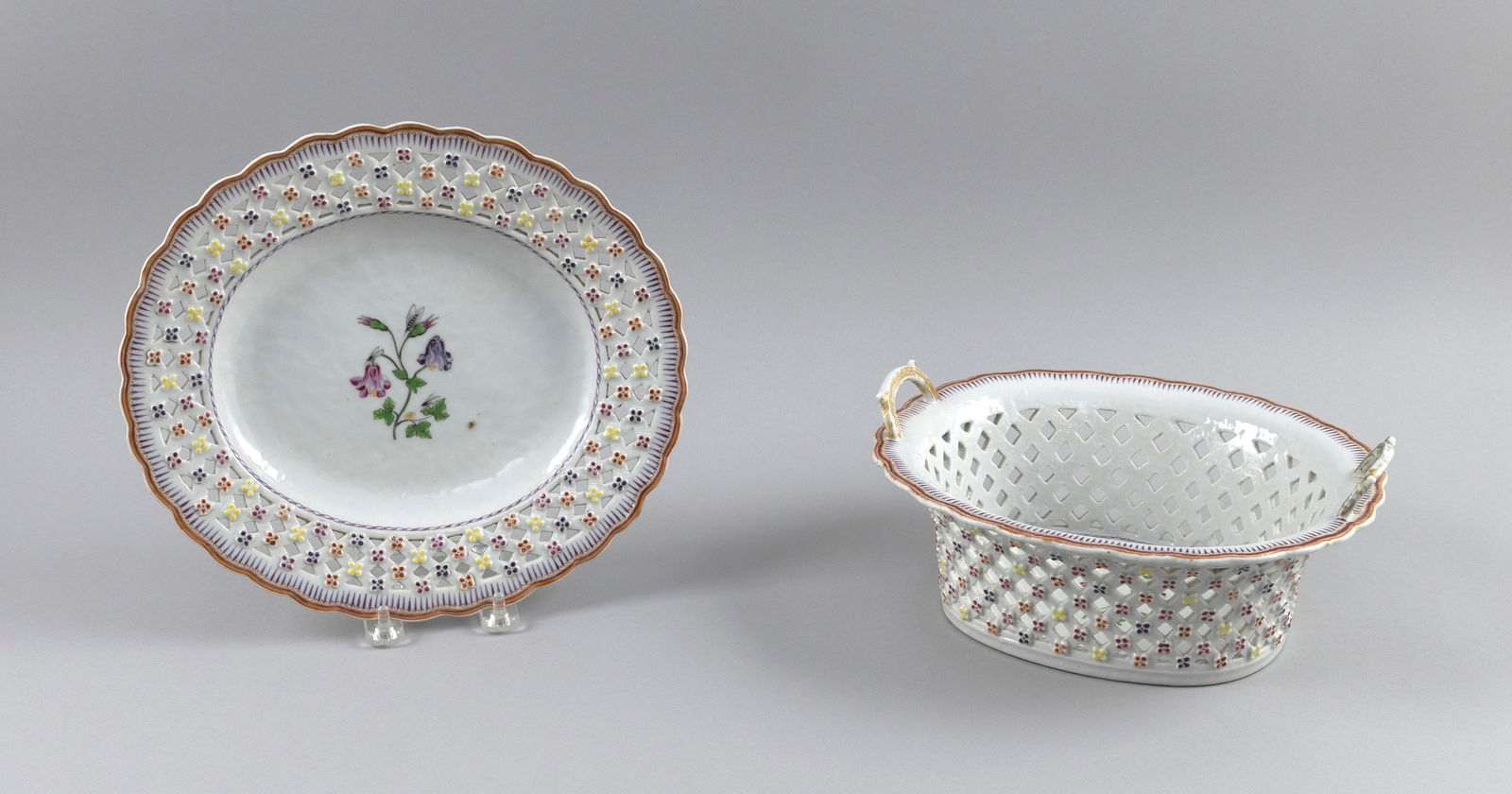 CHINESE EXPORT PORCELAIN BASKET WITH UNDERTRAY 18th Century Total height 5". Undertray length 11".: CHINESE EXPORT PORCELAIN BASKET WITH UNDERTRAY18th CenturyBasket's reticulated sides and undertray's reticulated rim accented with molded rosettes. Shaped edges. Both with matching painted floral deco