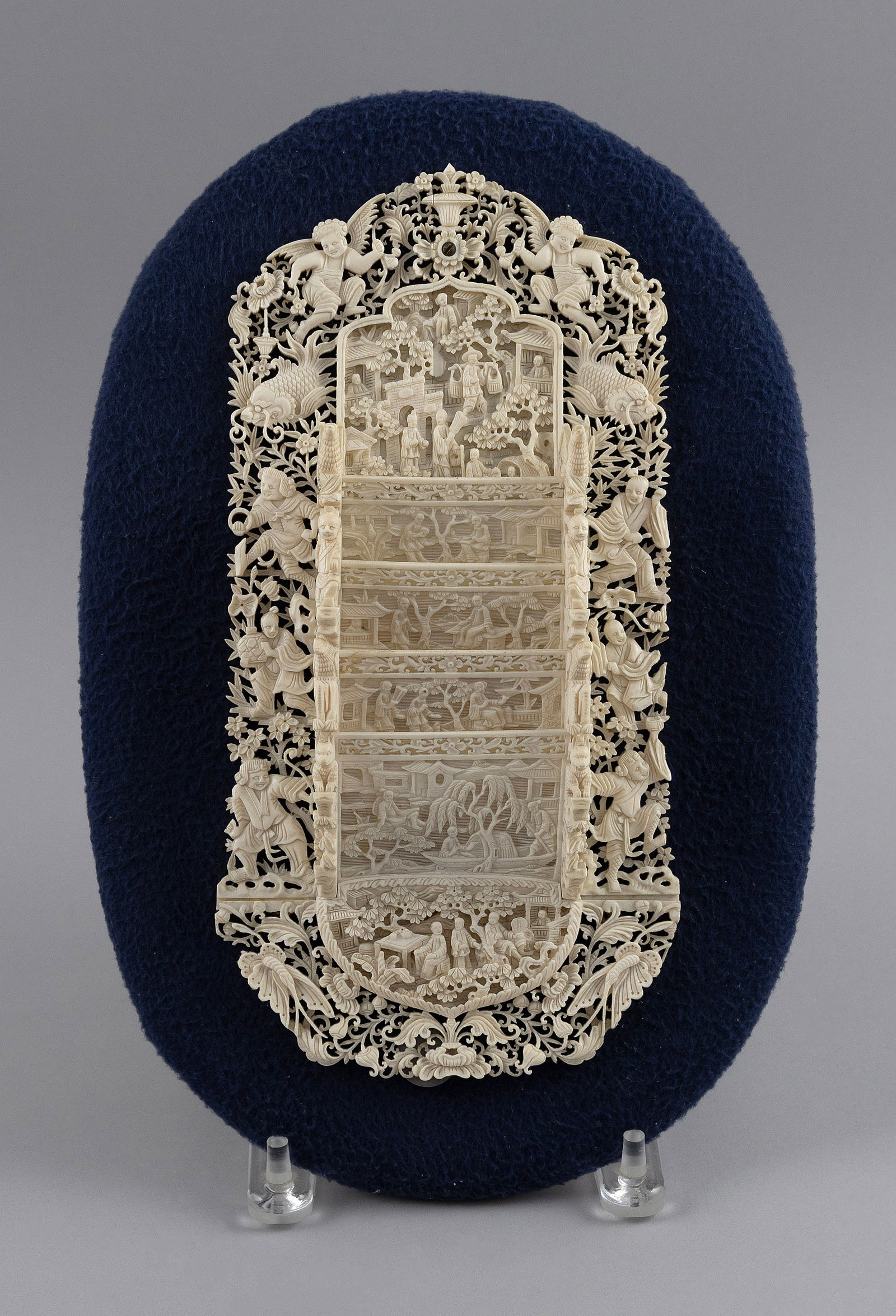 EXCEPTIONAL CHINESE EXPORT CARVED IVORY WALL POCKET 19th Century Wall pocket height 10.75". Width: EXCEPTIONAL CHINESE EXPORT CARVED IVORY WALL POCKET19th CenturyDelicate pierced and relief-carved design of figures, leaves, interior scenes, etc. Mounted on a contemporary felt-covered panel.Wall poc