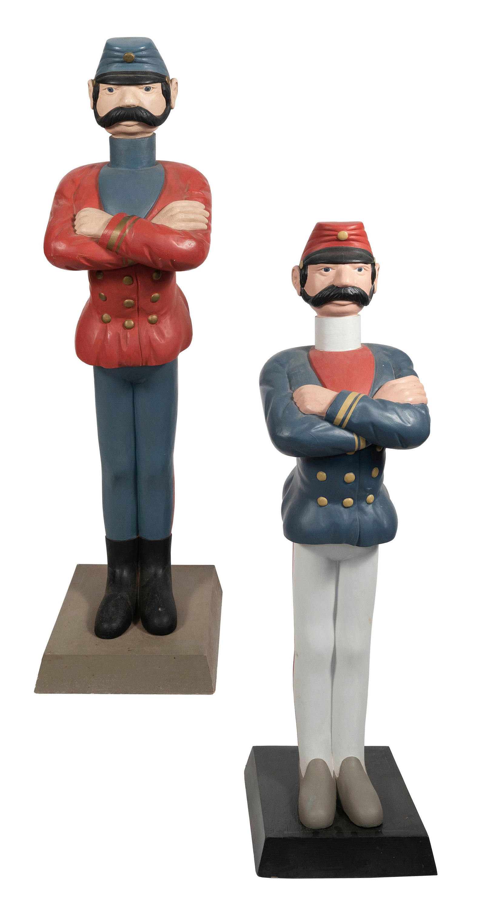 PAIR OF FOLK ART CARVED AND PAINTED SOLDIERS BY PAUL WHITE Cape Cod, Contemporary Heights 56".: PAIR OF FOLK ART CARVED AND PAINTED SOLDIERS BY PAUL WHITECape Cod, ContemporaryMustachioed soldiers in red, white and blue uniforms standing with their arms crossed. Square bases.Heights 56".