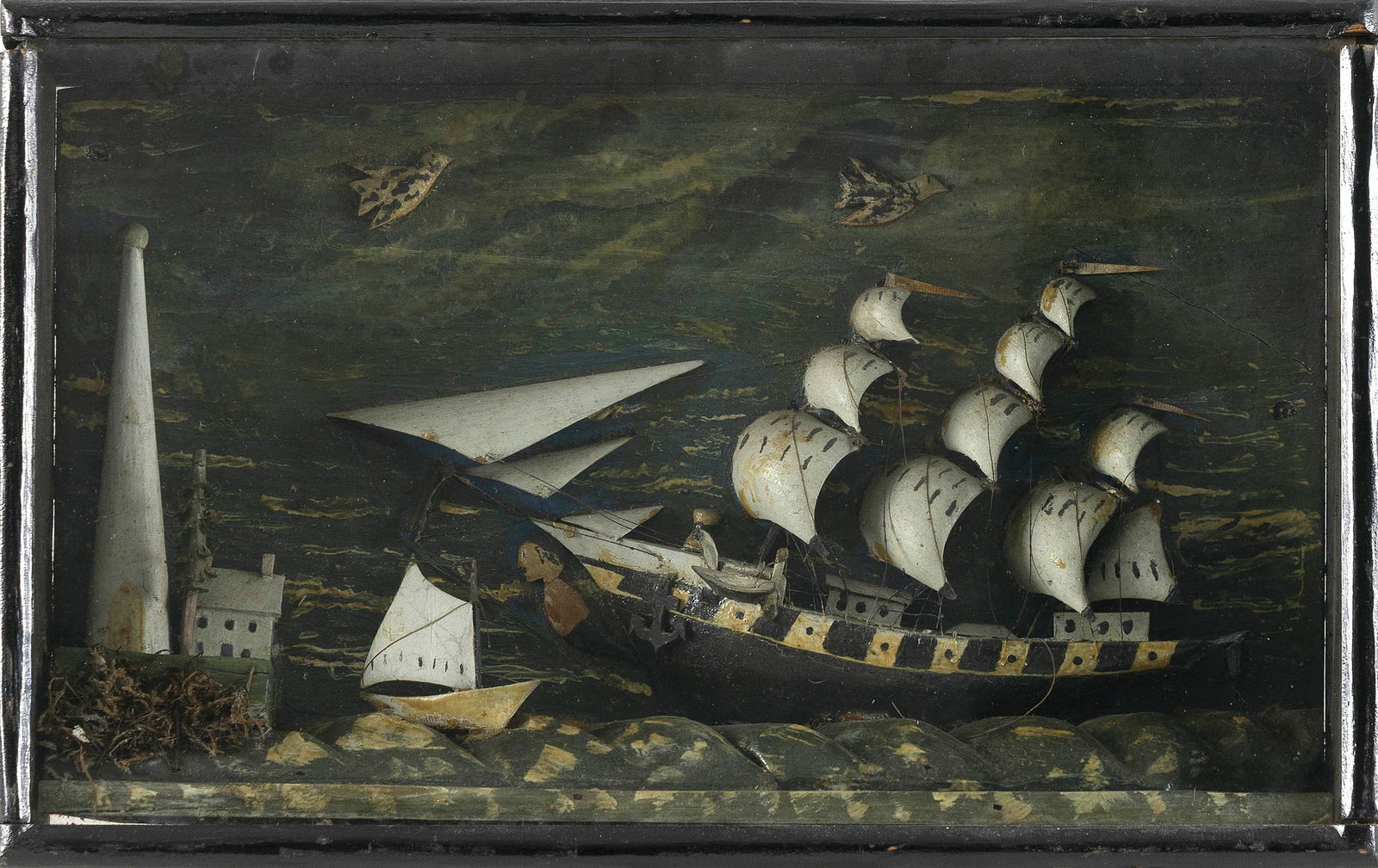 DIMINUTIVE MARITIME DIORAMA Late 19th/Early 20th Century Case height 9.75". Width 15.5". Depth 3".: DIMINUTIVE MARITIME DIORAMALate 19th/Early 20th CenturyDepicts a three-masted ship with an exaggerated figurehead off an island lighthouse. Carved and painted waves. Painted sky background with applie