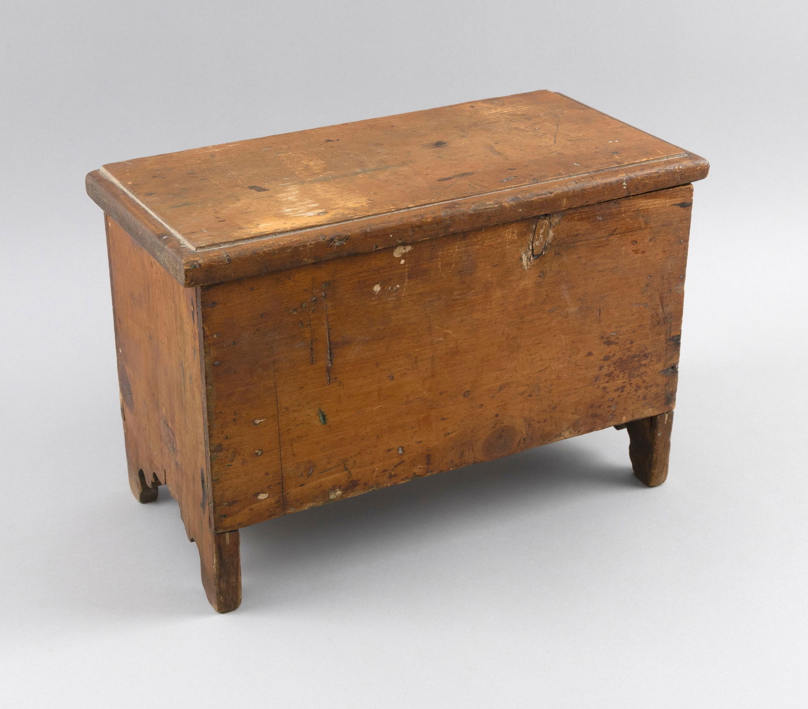 MINIATURE SIX-BOARD PINE BLANKET CHEST First Half of the 19th Century Height 10.5". Width 14.75".: MINIATURE SIX-BOARD PINE BLANKET CHESTFirst Half of the 19th CenturyHinged lid with molded edge. Modified bootjack ends.Height 10.5". Width 14.75". Depth 7.25". Provenance:The Collection of William