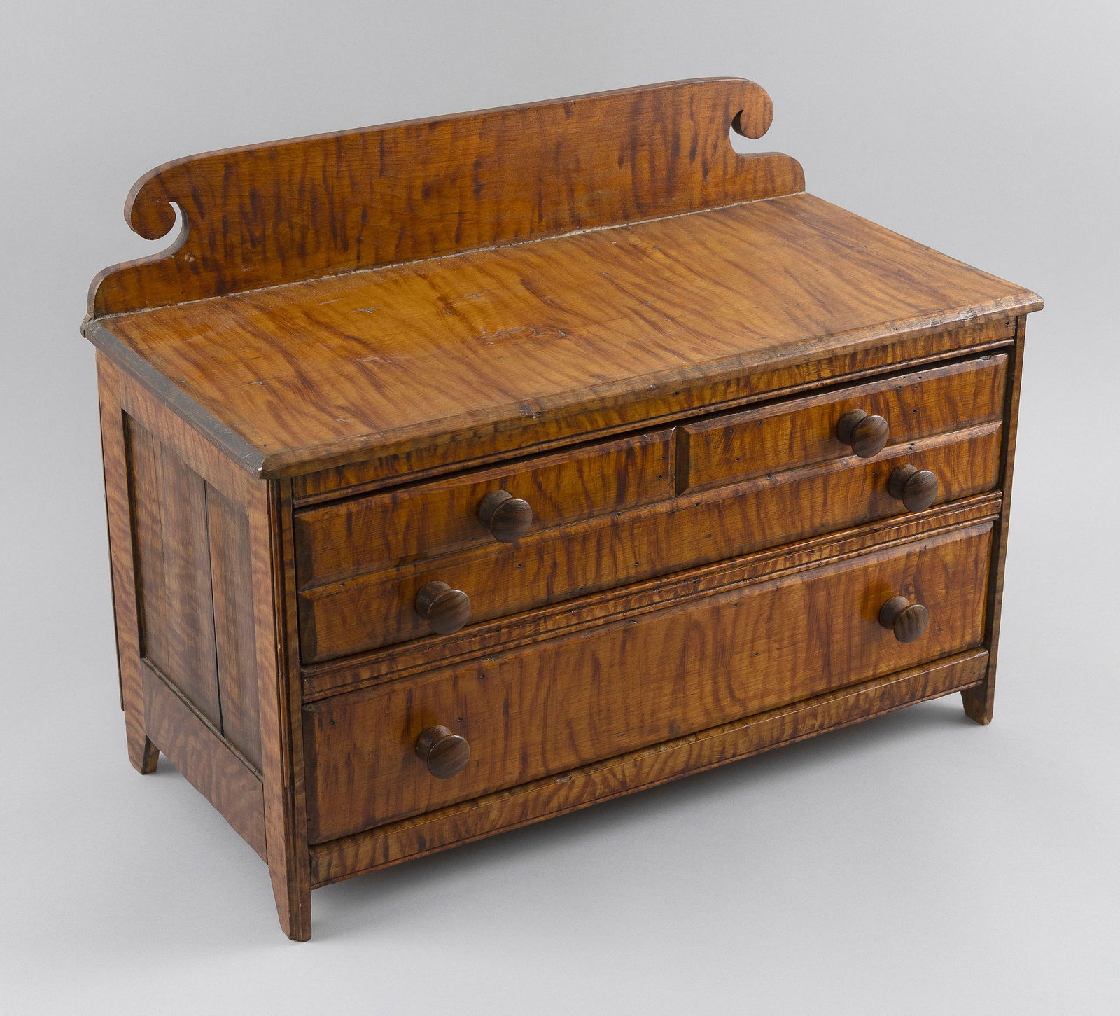 MINIATURE GRAIN-PAINTED PINE CHEST OF DRAWERS 19th Century Height 14.25". Width 19". Depth 9".: MINIATURE GRAIN-PAINTED PINE CHEST OF DRAWERS19th CenturyPainted to resemble tiger maple. Fitted with two drawers, the upper drawer simulating half drawers over a full-width drawer.Height 14.25". Widt