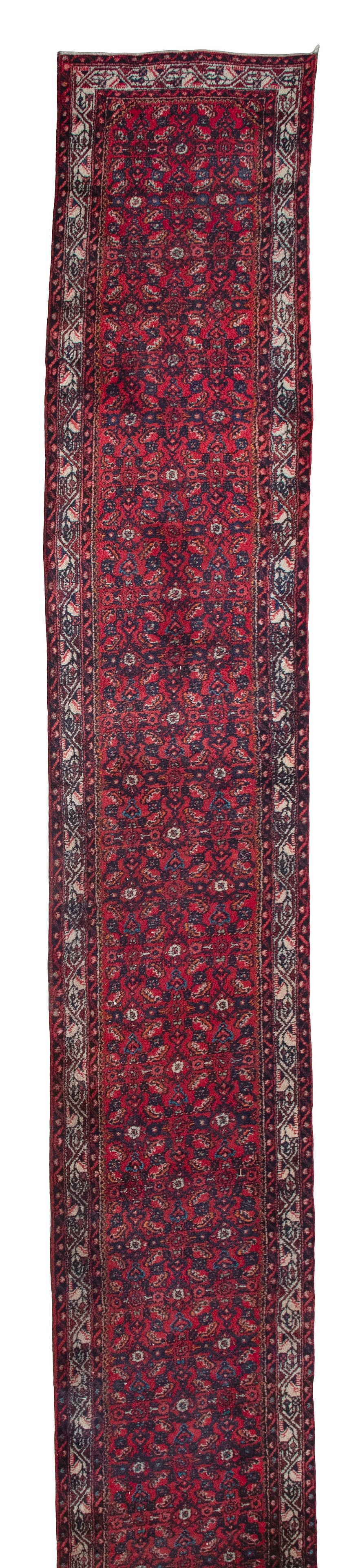 PERSIAN RUNNER 2'6" X 19'8" Second Quarter of the 20th Century: PERSIAN RUNNER 2'6" X 19'8"Second Quarter of the 20th CenturyRich red field with two columns of Herati pattern in dark blue, ivory, and subtle bits of bright bengal orange, azure blue and light green.