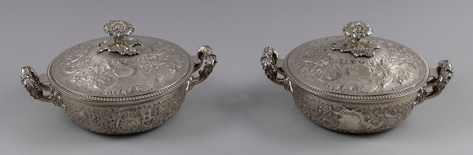 PAIR OF FRENCH STERLING SILVER LIDDED CASSEROLE DISHES Early 19th Century Approx. 88.2 troy oz.: PAIR OF FRENCH STERLING SILVER LIDDED CASSEROLE DISHESEarly 19th CenturyFrench standard mark for 1819-1838. Untraced maker's mark. Stamped for retailer Cosson-Corby. Ornate floral and scrolling foliag