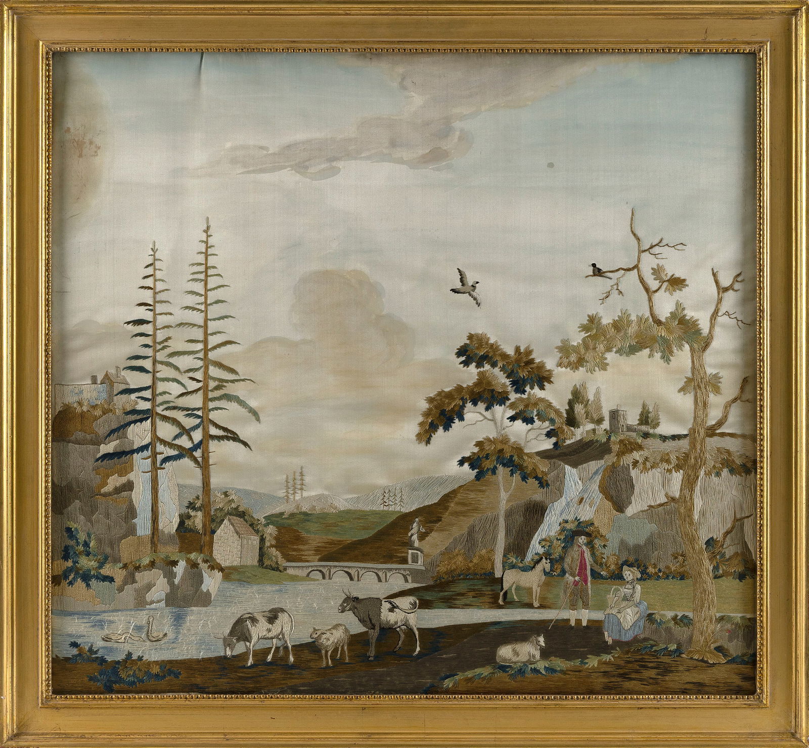 FINE ENGLISH PICTORIAL NEEDLEWORK 19th Century 24.5" x 26.75". Framed 28.5" x 30.75".: FINE ENGLISH PICTORIAL NEEDLEWORK19th CenturyDepicts a man and a woman tending to their farm animals in a mountain river landscape. Stitched on a painted silk ground.24.5" x 26.75". Framed 28.5" x 30.