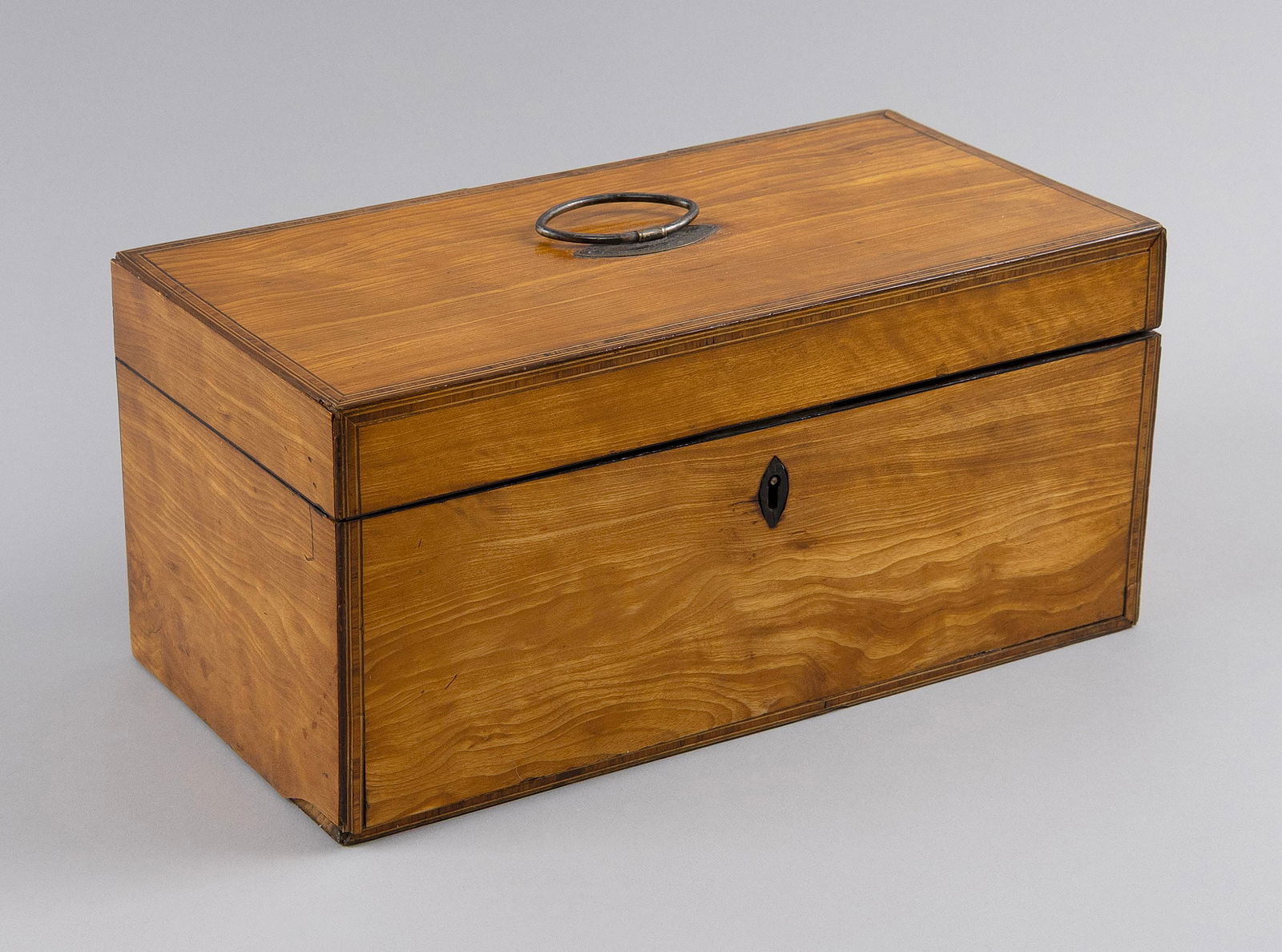 ENGLISH SELECT CHERRY VENEER TEA CADDY Second Quarter of the 19th Century Height 5.75". Width: ENGLISH SELECT CHERRY VENEER TEA CADDYSecond Quarter of the 19th CenturyInterior with two tea storage compartments and a receptacle for a waste bowl.Height 5.75". Width 12.25". Depth 6".