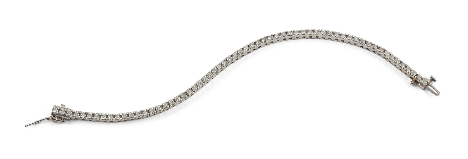 14KT WHITE GOLD AND DIAMOND TENNIS BRACELET Approx. 8.5 total dwt.: 14KT WHITE GOLD AND DIAMOND TENNIS BRACELET62 small round-cut diamonds, approx. 1.88 ctw. Box clasp with double safety. Stamped. Width approx. 3.0mm. Length 7".Approx. 8.5 total dwt.