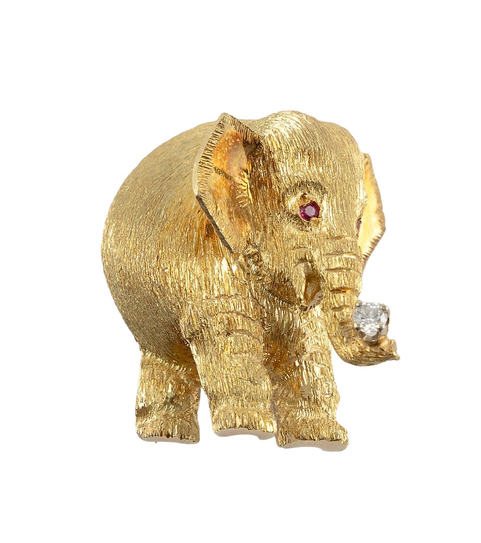 18KT YELLOW GOLD, RUBY AND DIAMOND ELEPHANT PIN Approx. 7.2 total dwt.: 18KT YELLOW GOLD, RUBY AND DIAMOND ELEPHANT PINTwo small round-cut ruby eyes and one approx. 0.03 ct. round-cut diamond on the trunk. Approx. 20.0 x 24.0mm.Approx. 7.2 total dwt.