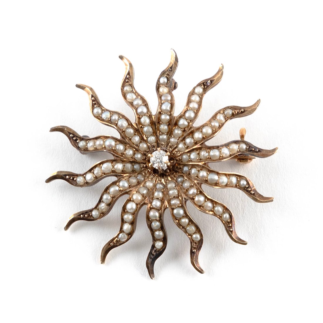 14KT YELLOW GOLD, SEED PEARL AND DIAMOND PIN/PENDANT Approx. 3.4 total dwt.: 14KT YELLOW GOLD, SEED PEARL AND DIAMOND PIN/PENDANTSunburst design with one small old European-cut diamond surrounded by small seed pearls. Diameter approx. 35.0mm.Approx. 3.4 total dwt.