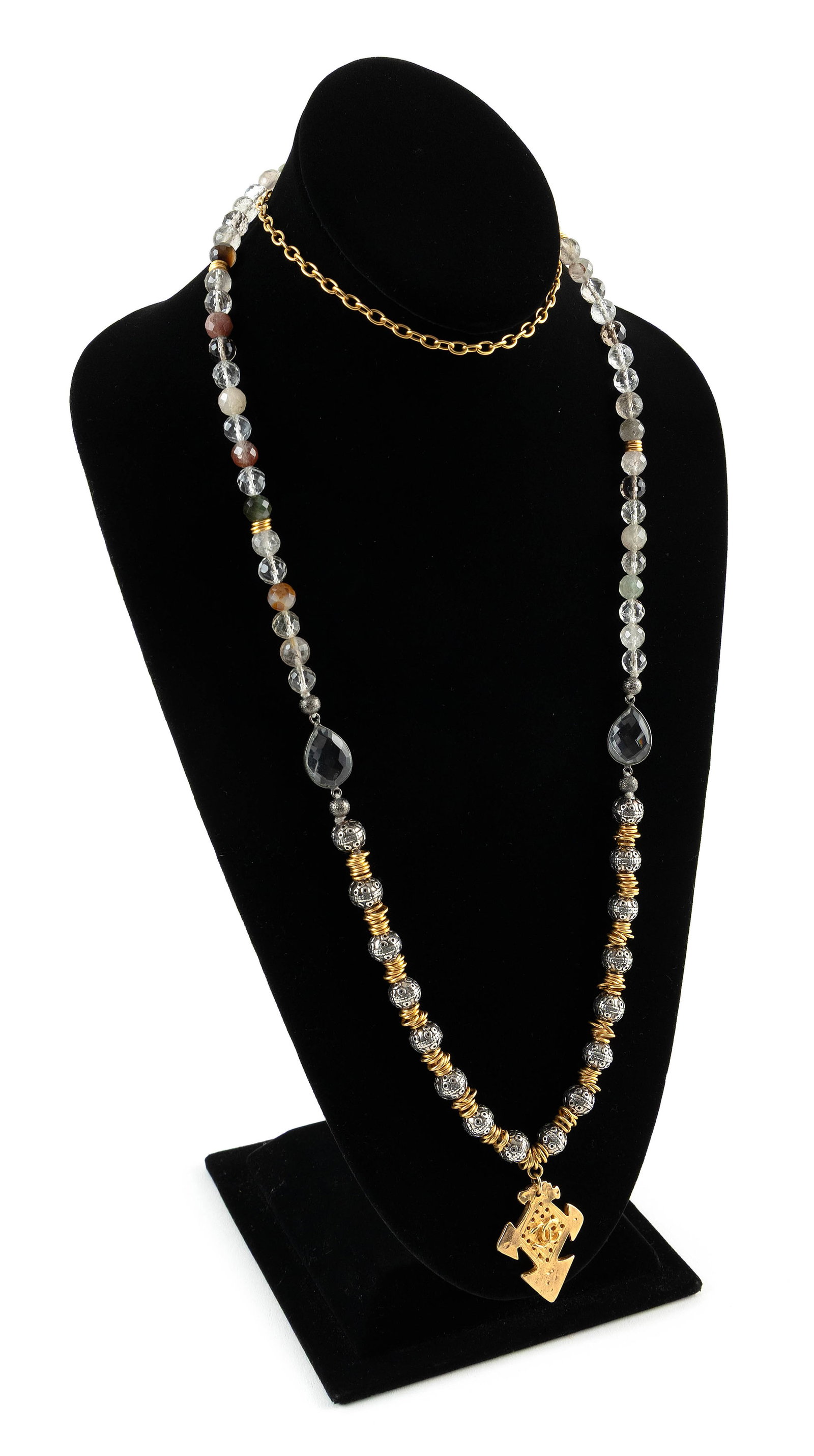 CHANEL SILVER, CRYSTAL AND STONE NECKLACE: CHANEL SILVER, CRYSTAL AND STONE NECKLACECross drop with Chanel logo. With silver metal beads, various faceted approx. 7.0mm round crystal beads and various faceted stone beads. Length 44".