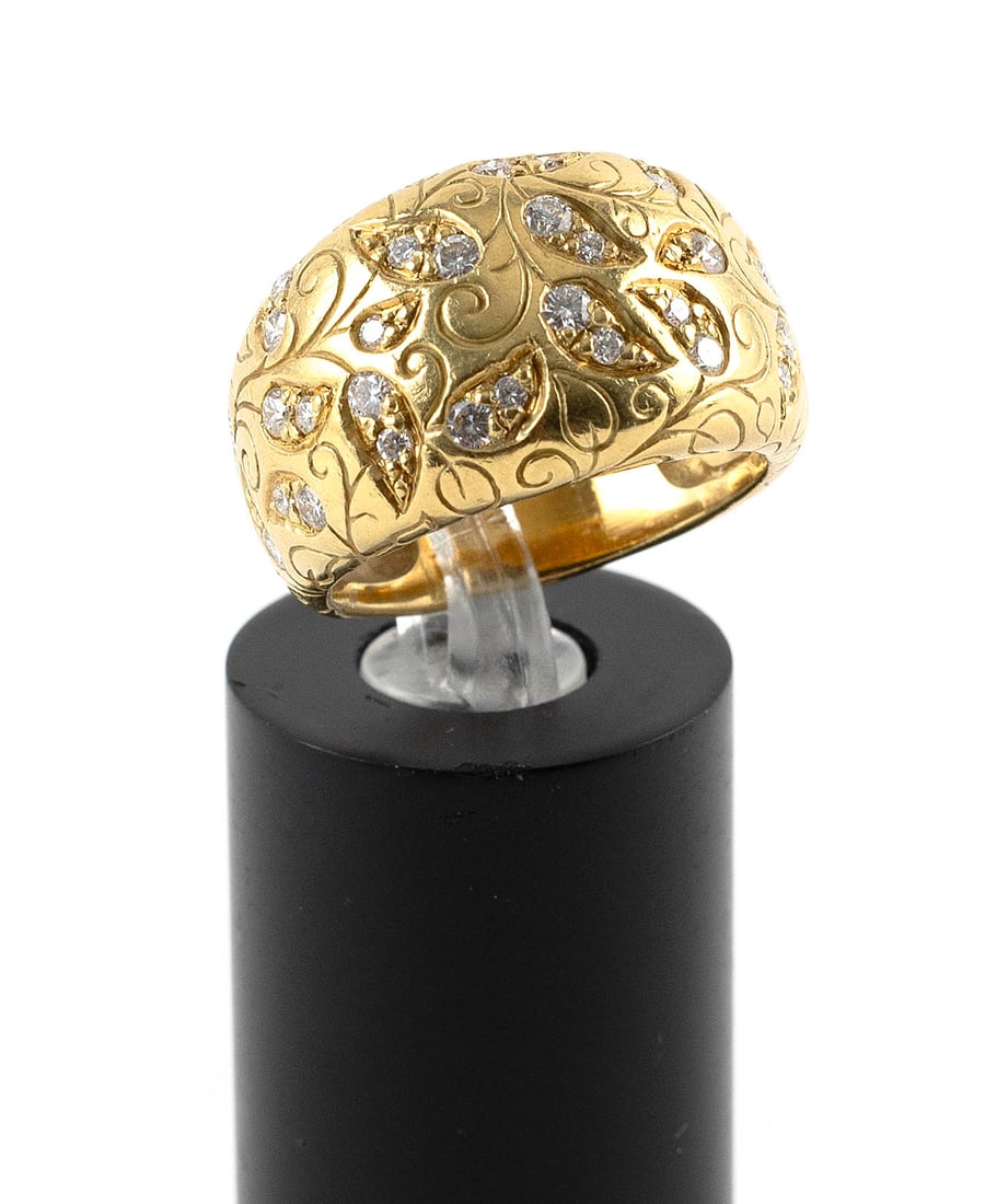 18KT YELLOW GOLD AND DIAMOND RING Approx. 6.7 total dwt.: 18KT YELLOW GOLD AND DIAMOND RINGDome style in a floral design with 26 small round-cut diamonds, approx. 0.50 ctw. Tapers from approx. 13.0 to 6.0mm. Stamped. Size 7.Approx. 6.7 total dwt.