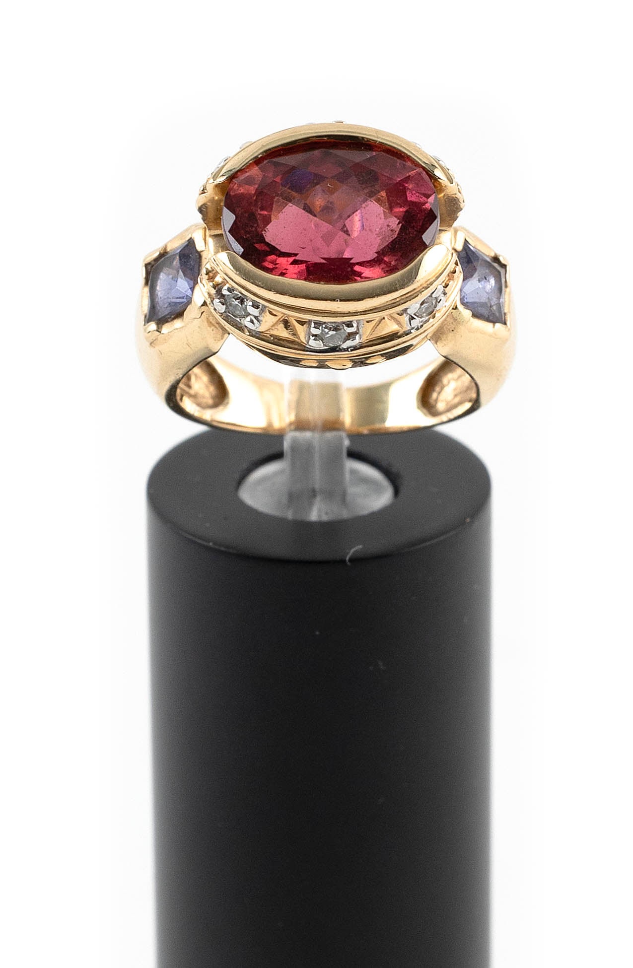 14KT YELLOW GOLD, RUBELLITE, TANZANITE AND DIAMOND RING Approx. 6.5 total dwt.: 14KT YELLOW GOLD, RUBELLITE, TANZANITE AND DIAMOND RINGOne approx. 9.0 x 12.0mm rubellite, two approx. 4.0 x 4.0mm square-cut tanzanites and six small round-cut diamonds. Size 6.Approx. 6.5 total dwt.