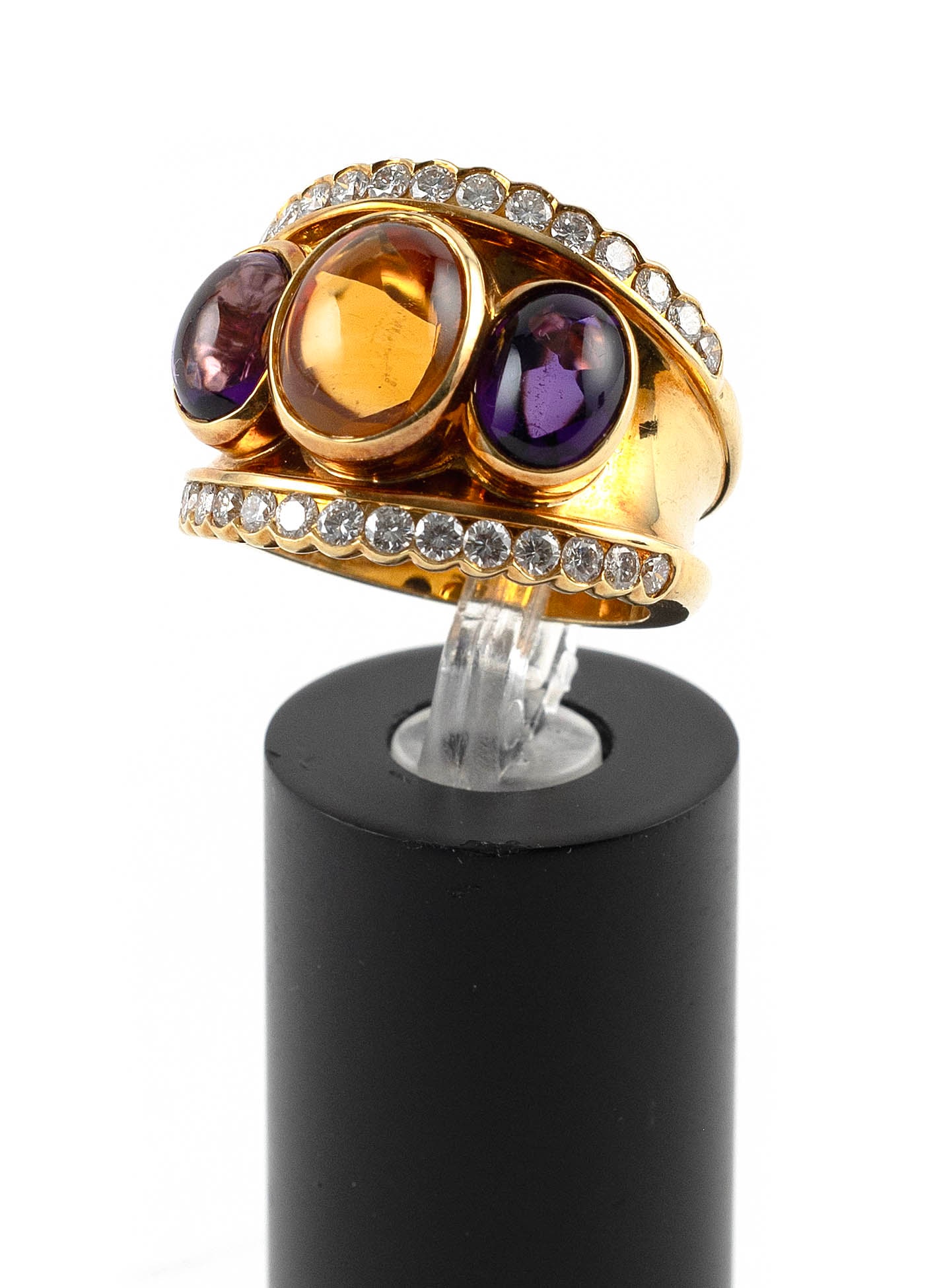 18KT YELLOW GOLD, DIAMOND, AMETHYST AND CITRINE RING Approx. 8.6 total dwt.: 18KT YELLOW GOLD, DIAMOND, AMETHYST AND CITRINE RINGOne approx. 7.0 x 10.0mm oval cabochon citrine with faceted underside, two approx. 5.0 x 7.0mm oval cabochon amethysts and 30 small round-cut diamon