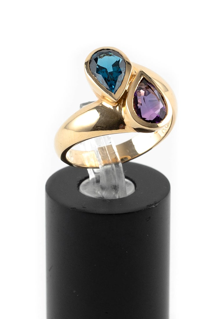 14KT YELLOW GOLD, AMETHYST AND BLUE TOPAZ RING Approx. 4.0 total dwt.: 14KT YELLOW GOLD, AMETHYST AND BLUE TOPAZ RINGBypass style with one approx. 5.0 x 8.0mm pear-shaped amethyst and one approx. 5.0 x 8.0mm pear-shaped blue topaz. Top approx. 12.0 x 17.0mm. Stamped. Siz