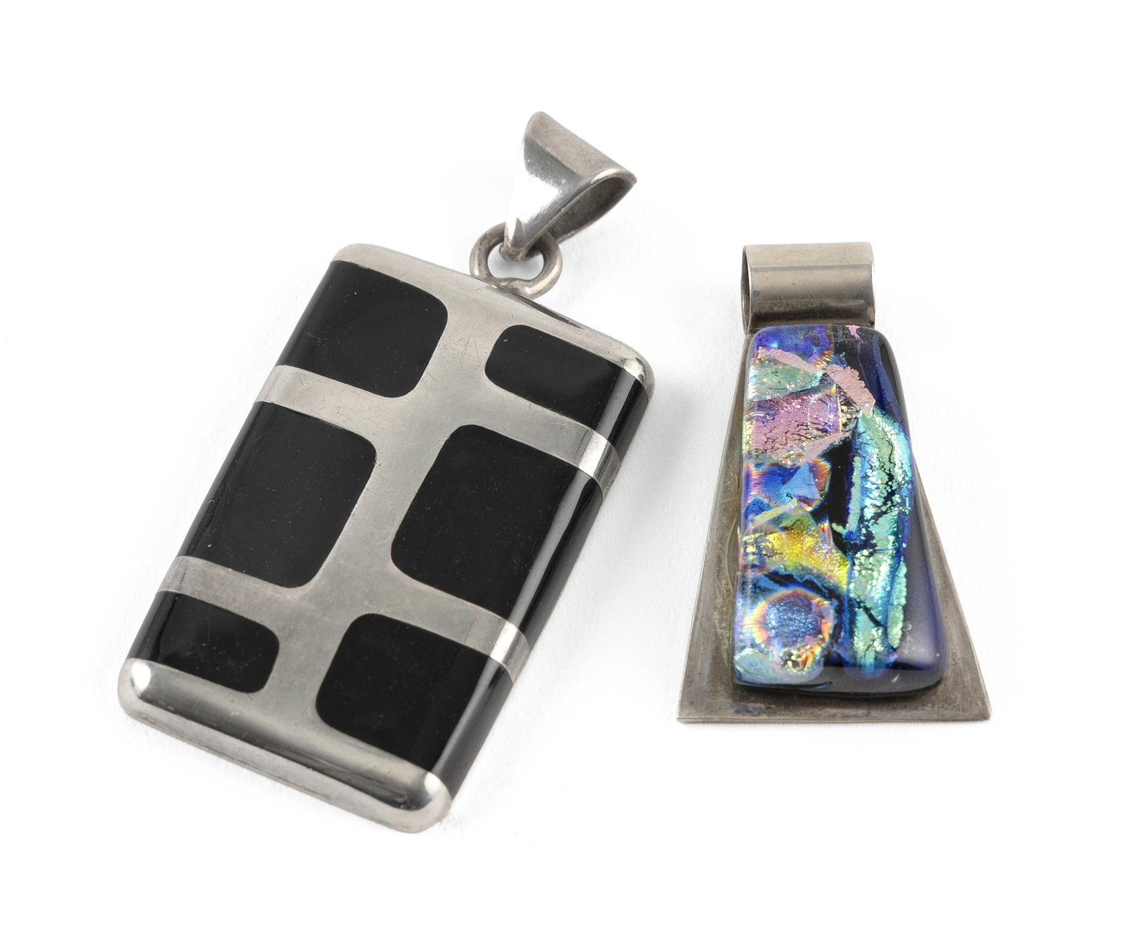 TWO STERLING SILVER PENDANTS Approx. 26.8 total dwt.: TWO STERLING SILVER PENDANTS1) With black onyx. Approx. 39.0 x 47.0 x 5.0mm.2) With art glass. Approx. 25.0 x 42.0 x 8.0mm.Both stamped.Approx. 26.8 total dwt.