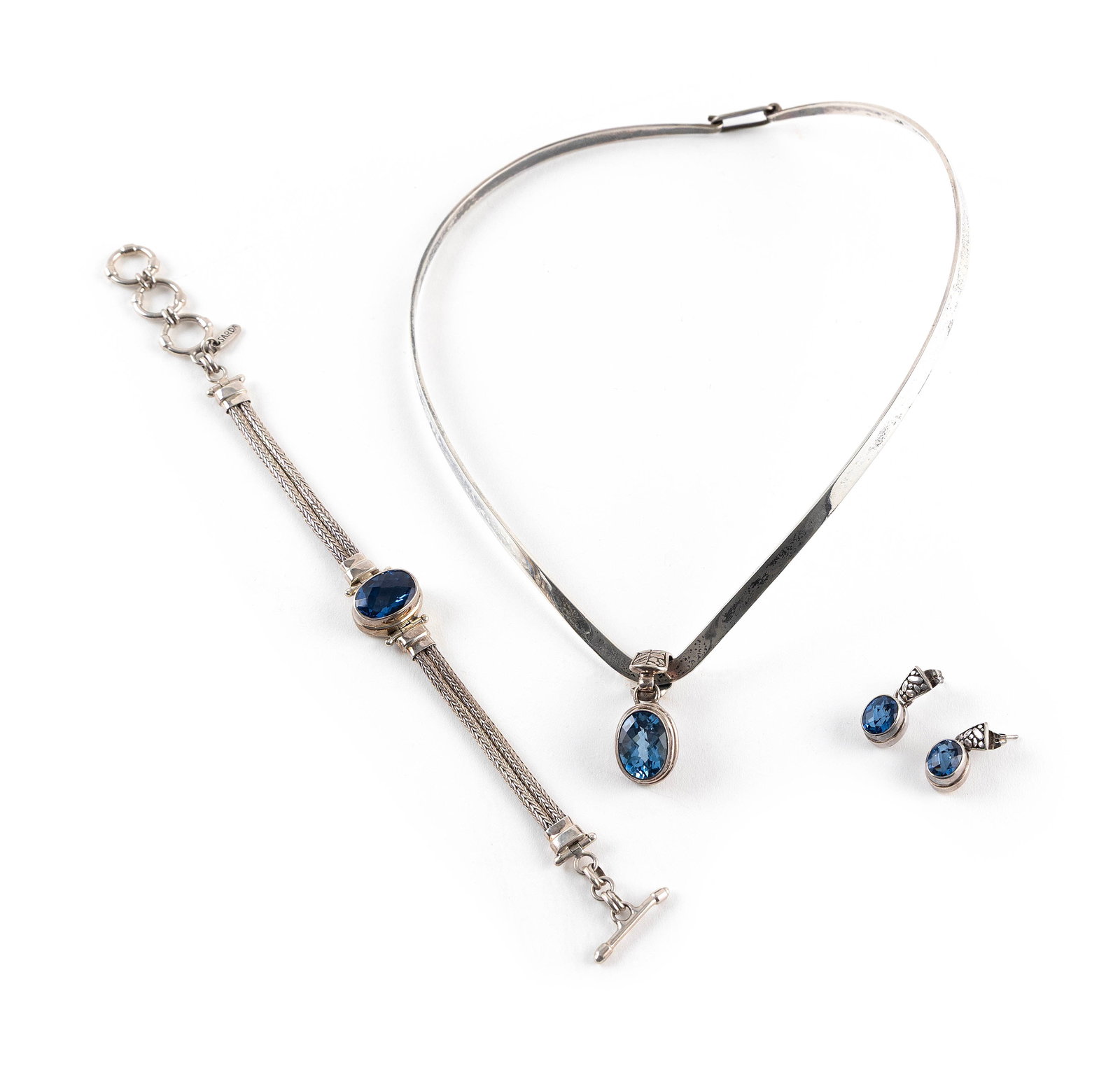 STERLING SILVER AND BLUE QUARTZ FOUR-PIECE PARURE Approx. 38.7 total dwt.: STERLING SILVER AND BLUE QUARTZ FOUR-PIECE PARURE1) "V" neck collar with an approx. 13.0 x 32.0mm slide with an approx. 10.0 x 14.0mm bezel-set oval-cut blue quartz. Width approx. 5.0mm. Length 16".2-