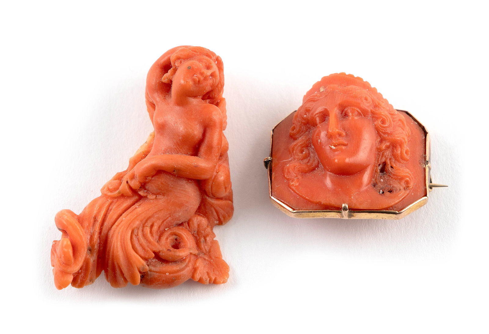 TWO 14KT YELLOW GOLD AND HAND-CARVED CORAL PINS: TWO 14KT YELLOW GOLD AND HAND-CARVED CORAL PINS1) Cameo style. Approx. 23.0 x 27.0mm.2) Figure of a woman. Approx. 31.0 x 42.0mm.Provenance:The Estate of Harold Smalley, Osterville, Massachusetts.