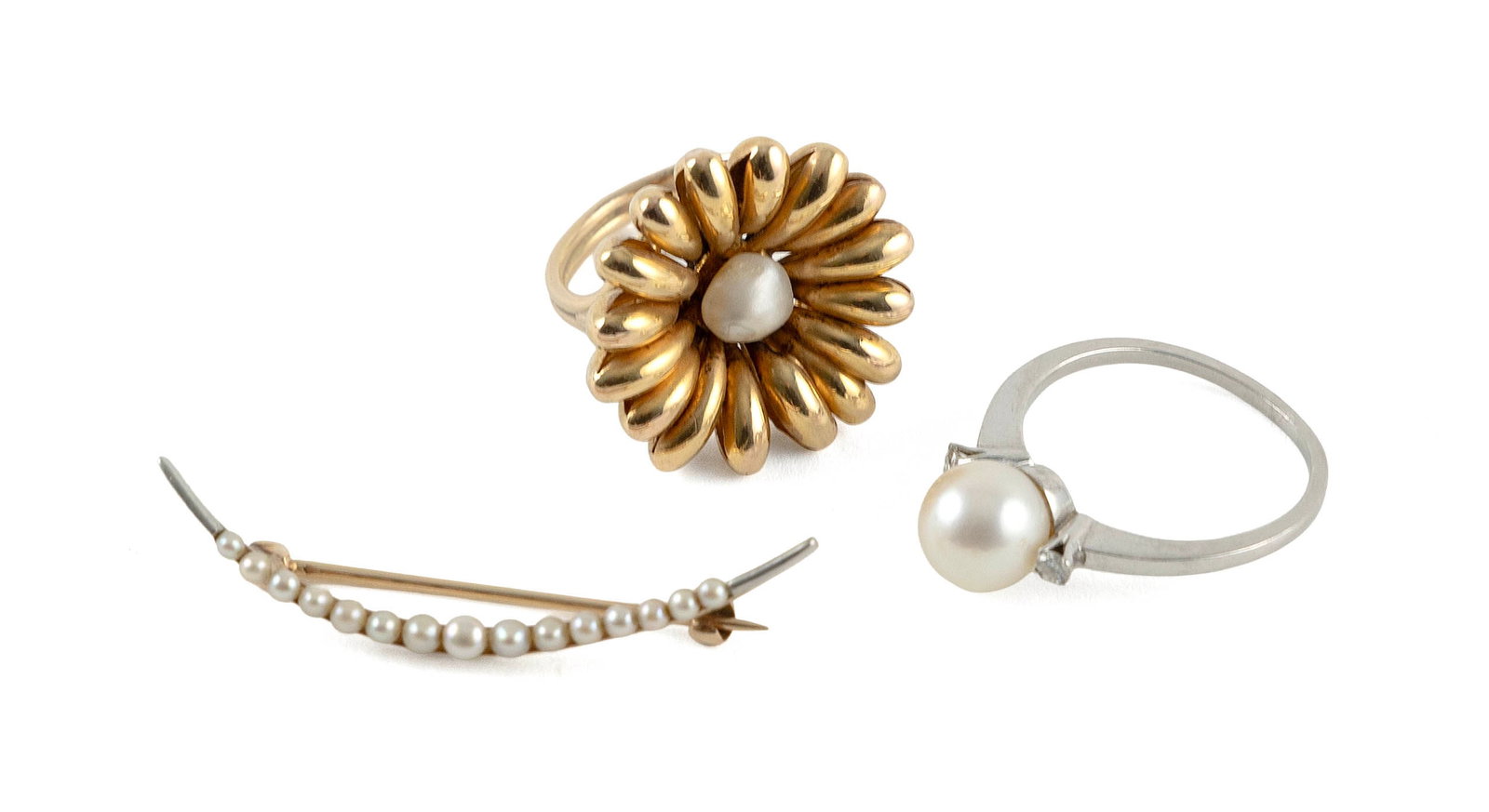 THREE PIECES OF 14KT GOLD AND PEARL JEWELRY Approx. 6.2 total dwt.: THREE PIECES OF 14KT GOLD AND PEARL JEWELRY1) Yellow gold and pearl pin in a crescent shape with 15 small seed pearls. Stamped. Approx. 2.0 x 39.0mm.2) Yellow gold ring in floral design with one appro