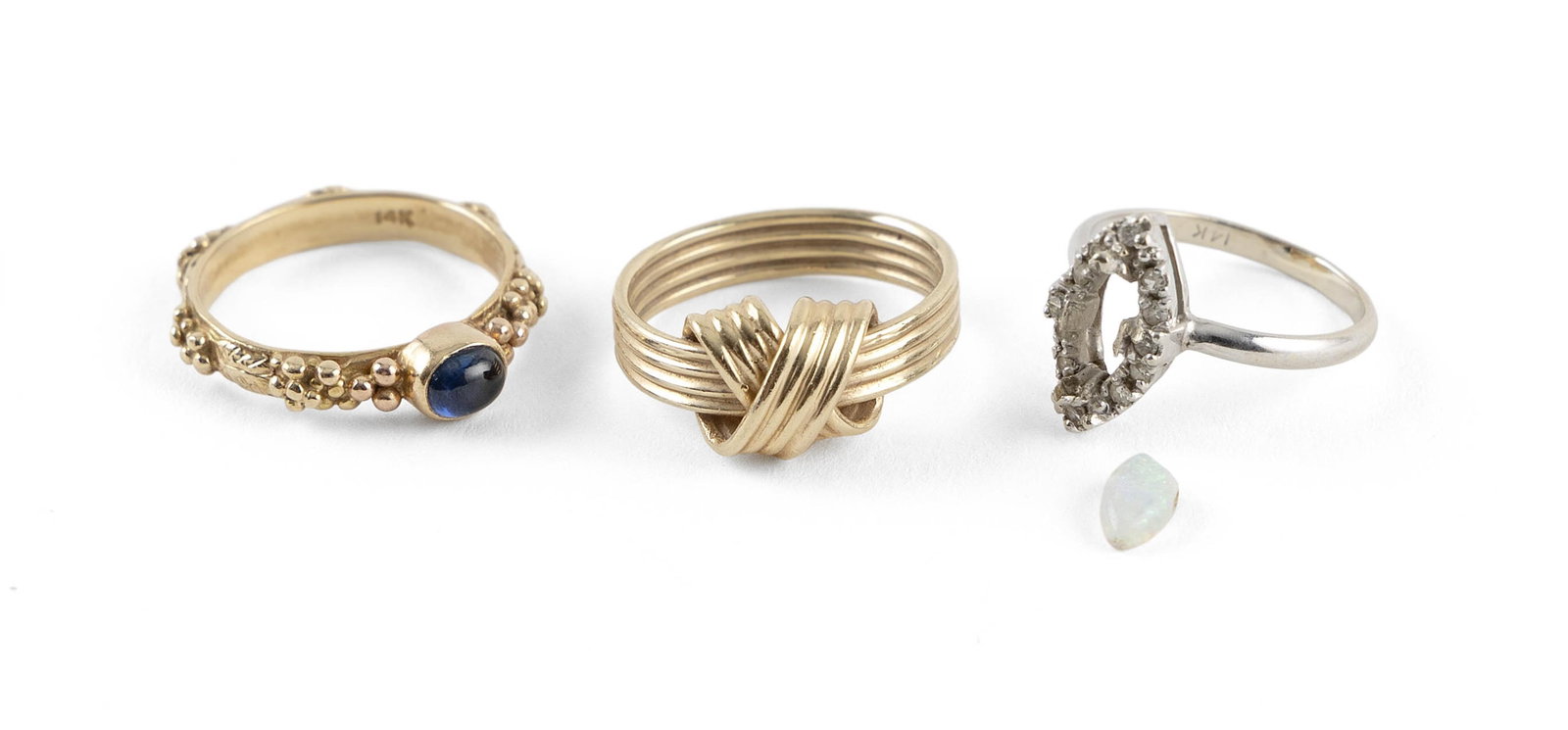THREE 14KT GOLD RINGS Approx. 5.5 total dwt.: THREE 14KT GOLD RINGS1) Yellow gold in a knot design. Top approx. 9.0 x 9.0mm. Band approx. 4.0mm band. Size 4.2) Yellow gold with one approx. 3.0 x 5.0mm oval cabochon blue spinel and a floral design