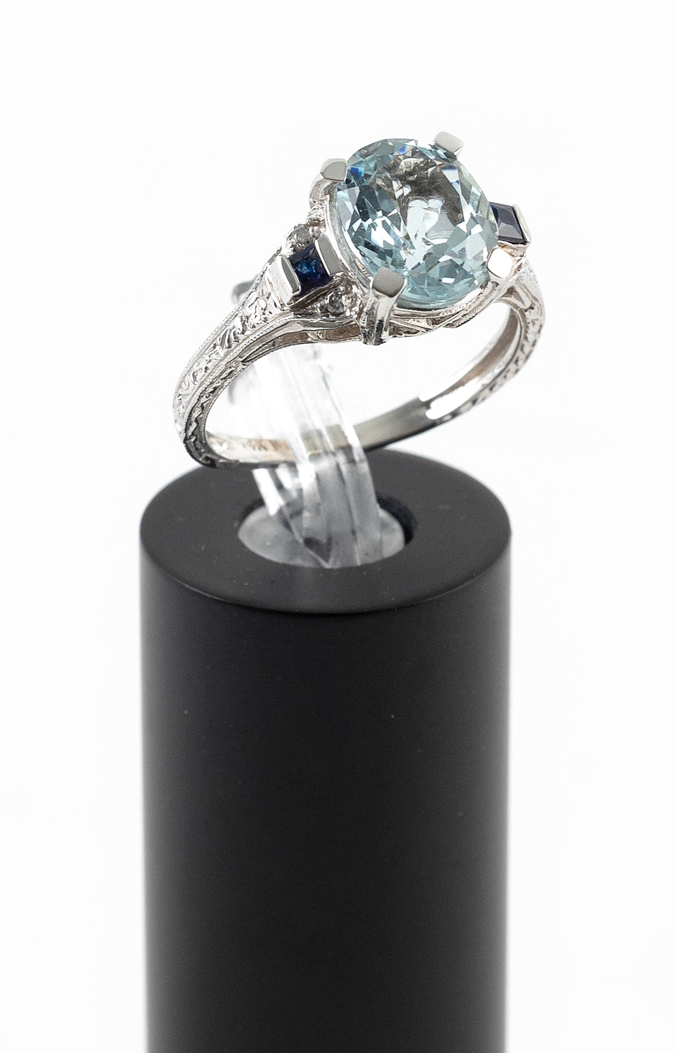 14KT WHITE GOLD, AQUAMARINE, SAPPHIRE AND DIAMOND RING Approx. 2.2 total dwt.: 14KT WHITE GOLD, AQUAMARINE, SAPPHIRE AND DIAMOND RINGOne approx. 8.0 x 10.0mm faceted oval aquamarine, two small square-cut sapphires and four small round-cut diamonds. Stamped. Size 6?.Approx. 2.2 t