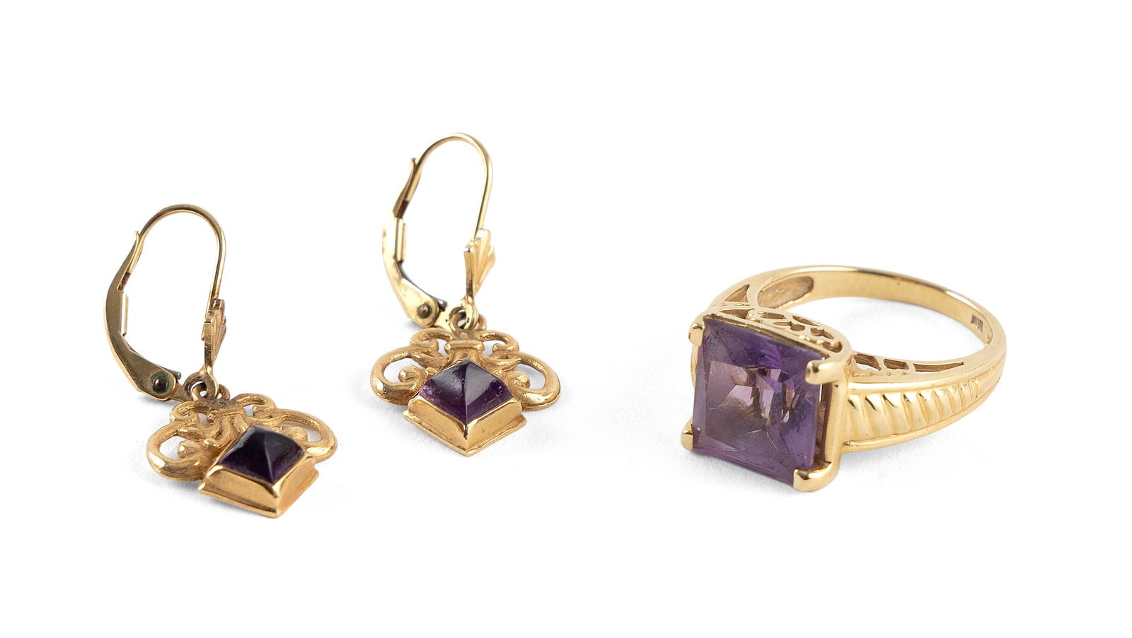 14KT YELLOW GOLD AND AMETHYST RING AND PAIR OF EARRINGS Approx. 4.7 total dwt.: 14KT YELLOW GOLD AND AMETHYST RING AND PAIR OF EARRINGS1) Ring with one approx. 10.0 x 10.0mm faceted amethyst. Stamped. Size 6.2) Pair of scroll-design earrings each with one approx. 4.0 x 4.0mm amet