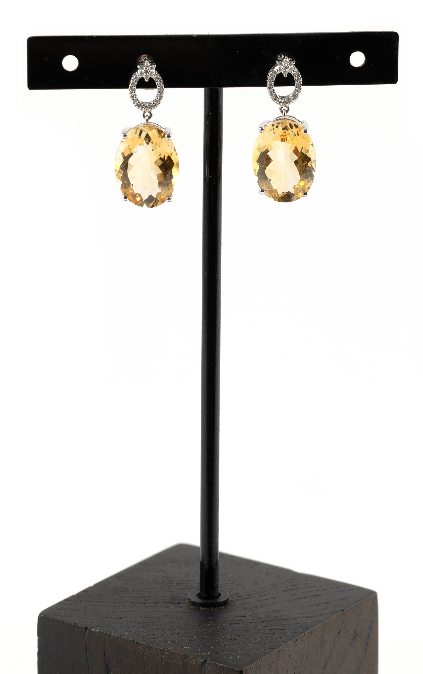 PAIR OF 14KT WHITE GOLD, CITRINE AND DIAMOND EARRINGS: PAIR OF 14KT WHITE GOLD, CITRINE AND DIAMOND EARRINGSEach with one approx. 12.0 x 16.0mm faceted oval citrine and 21 small single-cut diamonds. Post backs with nuts. Stamped.