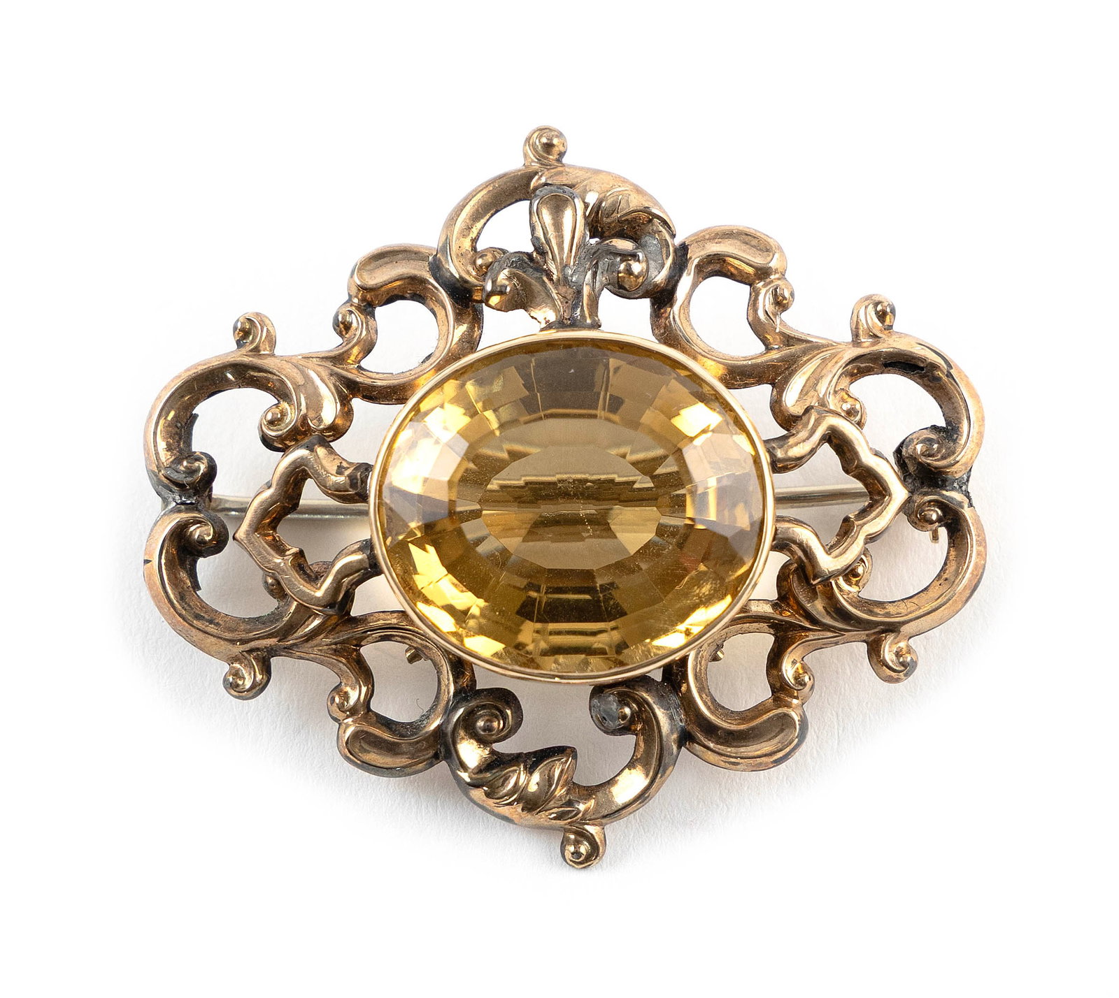 10KT YELLOW GOLD AND CITRINE BROOCH: 10KT YELLOW GOLD AND CITRINE BROOCHVictorian design with one approx. 18.0 x 20.0mm faceted oval citrine. Approx. 40.0 x 46.0mm.