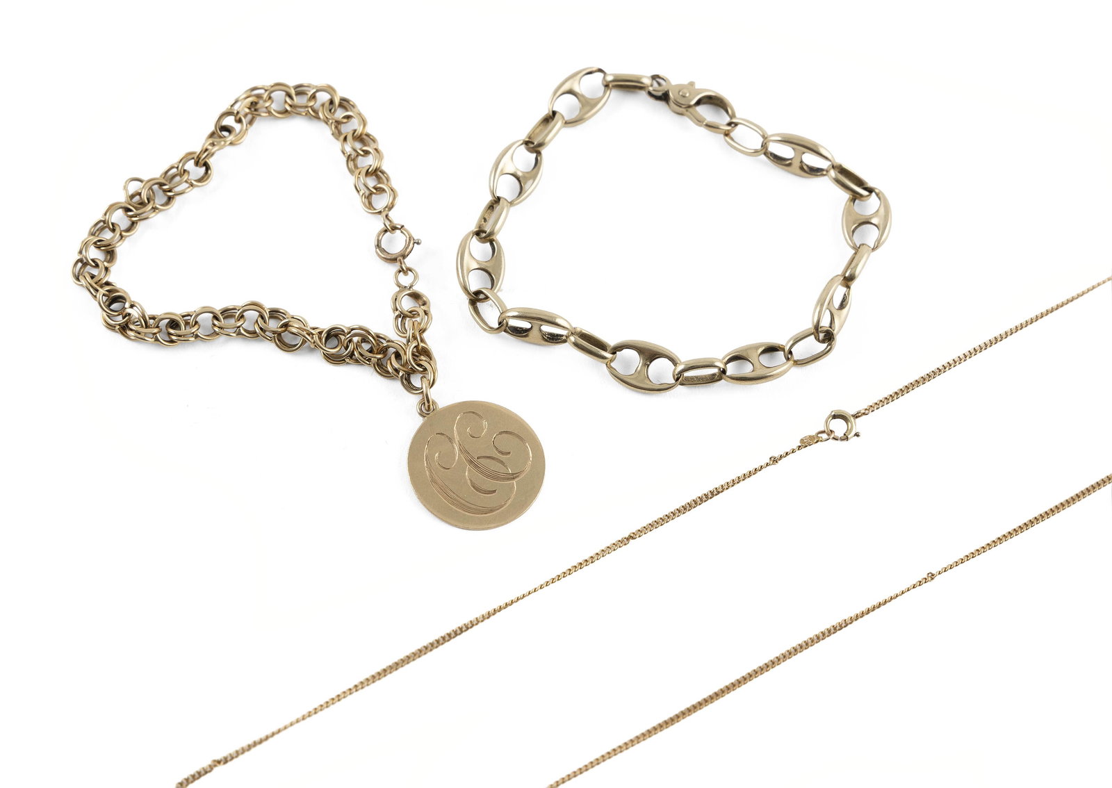 THREE PIECES OF 14KT YELLOW GOLD JEWELRY Approx. 18.0 total dwt.: THREE PIECES OF 14KT YELLOW GOLD JEWELRY1) Mariner-link bracelet. Lobster claw clasp. Width approx. 8.0mm. Length 7.5".2) Double-link bracelet with one approx. 21.0mm round engraved charm. Spring ring