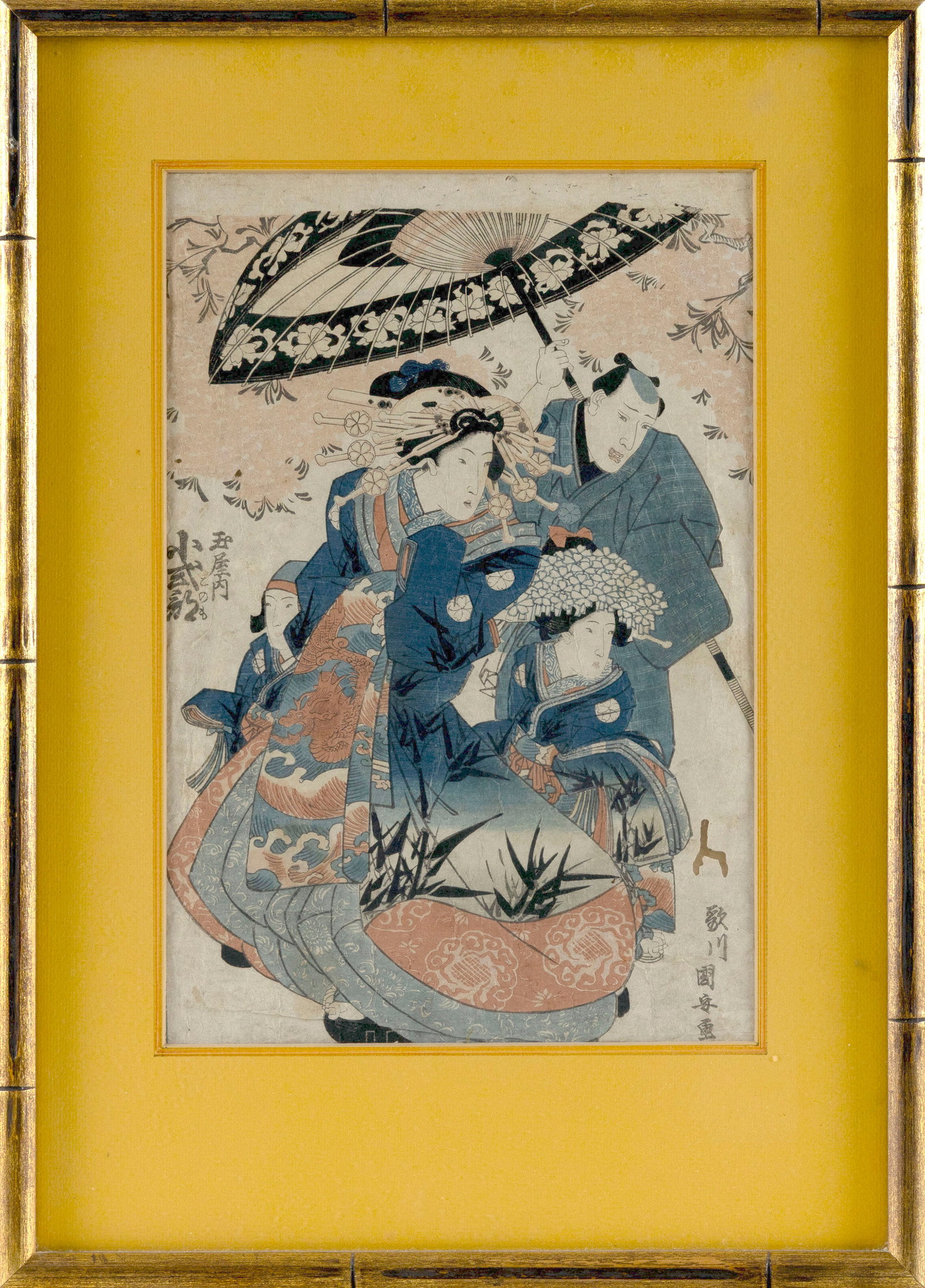 Three figures under an umbrella. (1 of 2)