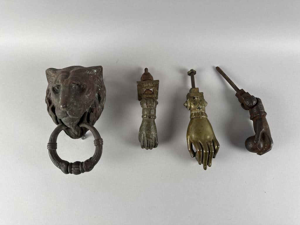 FOUR DOOR KNOCKERS 19th Century: FOUR DOOR KNOCKERS 19th Century 1) Gilt metal lion's mask with ring. Length 9". 2) Victorian brass hand and ball. Length 7". 3) Iron hand and ball, the backplate showing traces of paint. Length 4.5". 