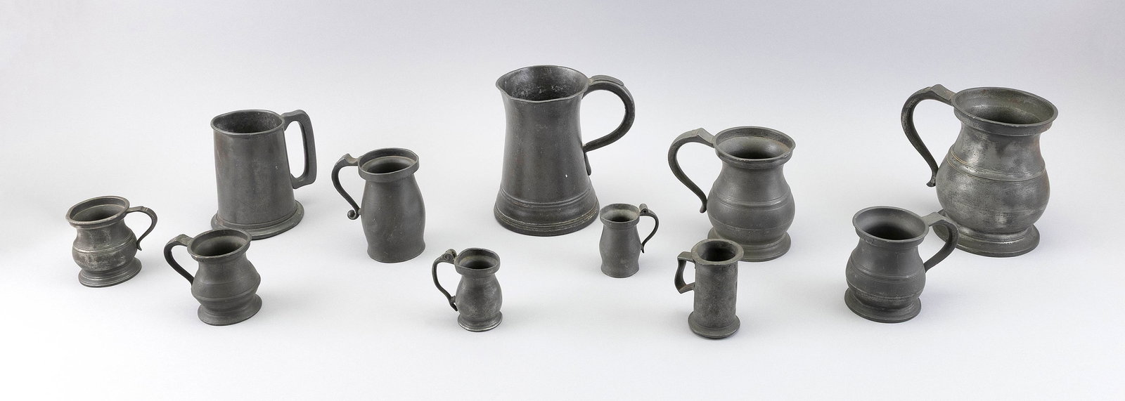 ELEVEN PEWTER TANKARDS AND MEASURES 18th/19th Century Heights from 3" to 6.5". (1 of 1)