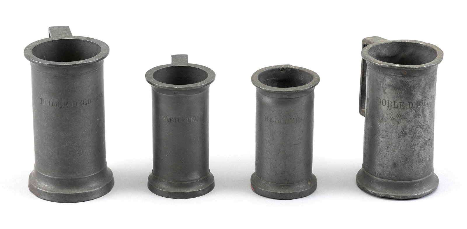 FOUR FRENCH PEWTER HANDLED MEASURES 19th/Early 20th Century Heights from 3.25" to 4.25". (1 of 2)