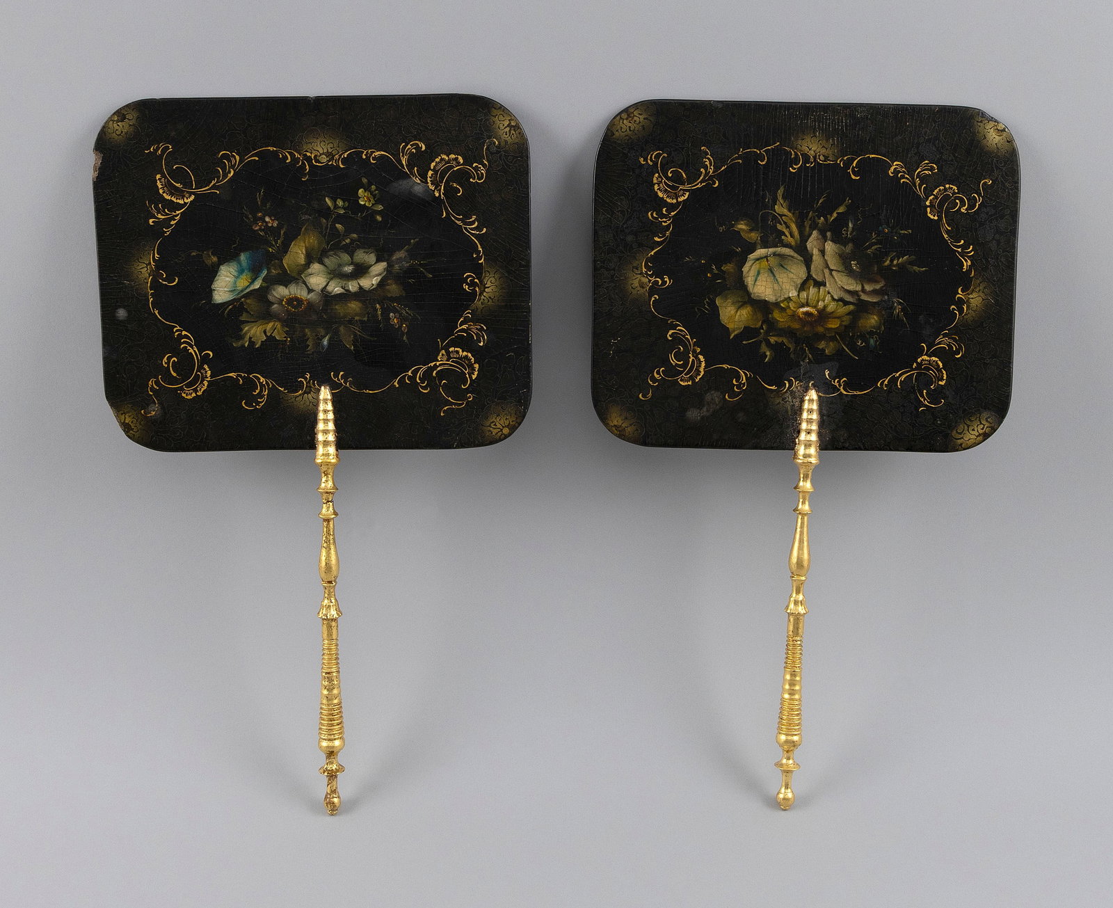 PAIR OF LACQUER PAPIER-MACHE FIREPLACE SCREENS Second Half of the 19th Century Lengths 15.25". Fan: PAIR OF LACQUER PAPIER-MACHE FIREPLACE SCREENS Second Half of the 19th Century Screens with floral decoration. Giltwood handles. Lengths 15.25". Fan panels 9" x 7.25". 