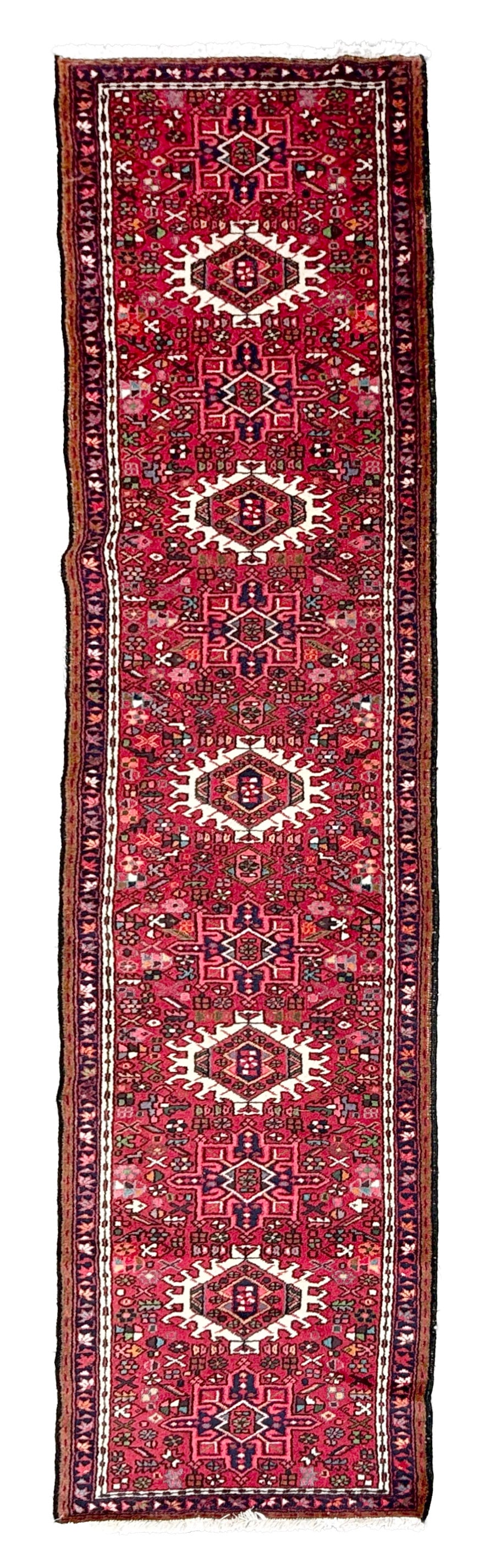 KARAJA RUG: 2'9" X 12'0" Second Half of the 20th Century: KARAJA RUG: 2'9" X 12'0" Second Half of the 20th Century Bright ivory, pink, red and blue medallions contain and are surrounded by various, colorful stylized micro-elements throughout a red field. Nar